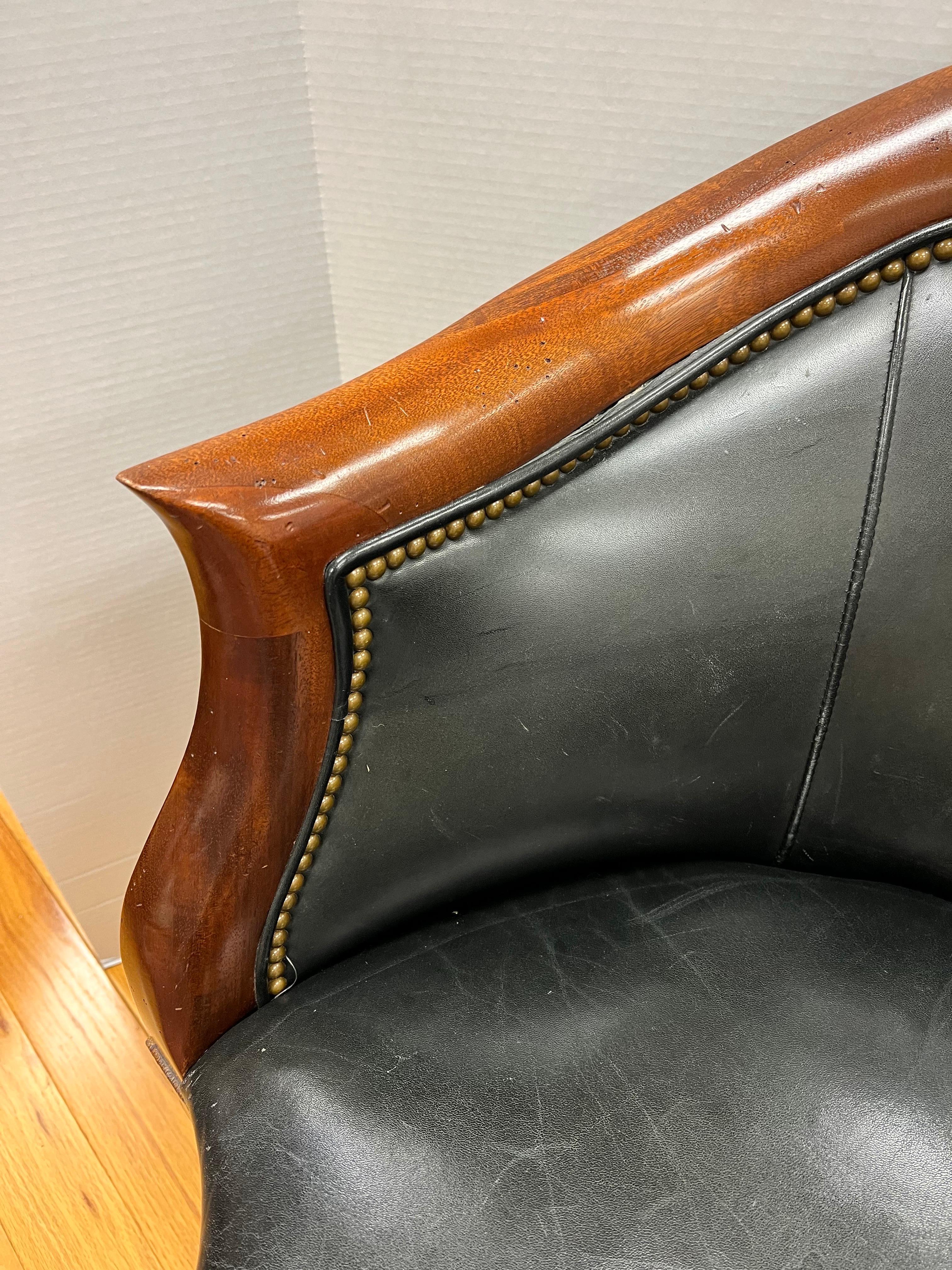 Handsome mahogany corner chair with soft black leather upholstery. Rich details include star inlay pattern and carved flute legs with antique brass nailheads all around. Tres elegant, indeed!