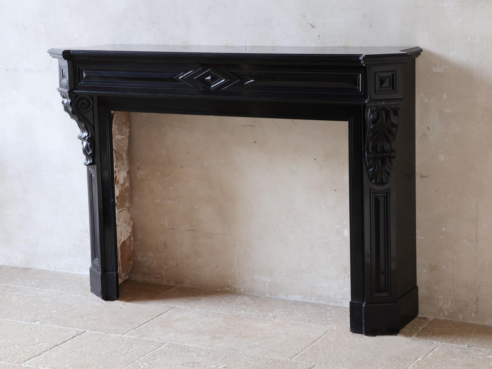 French Antique black marble Modillion mantelpiece For Sale