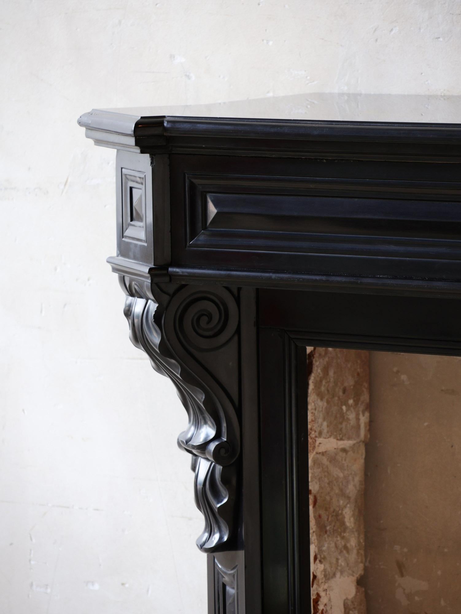 Marble Antique black marble Modillion mantelpiece For Sale