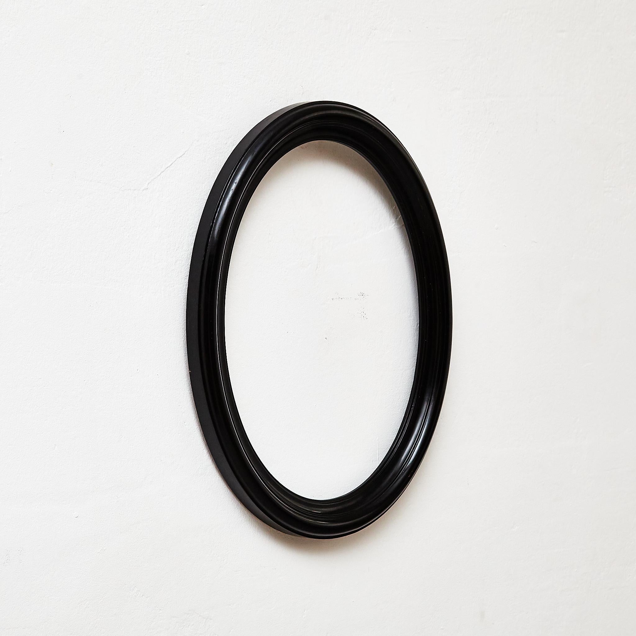 Antique Black Oval Wood Laquered Frame.

Manufactured France, circa 1940.

Materials:
Wood

Dimensions: 
D 3 x W 35 cm x H 45 cm

In original condition, with minor wear consistent with age and use, preserving a beautiful