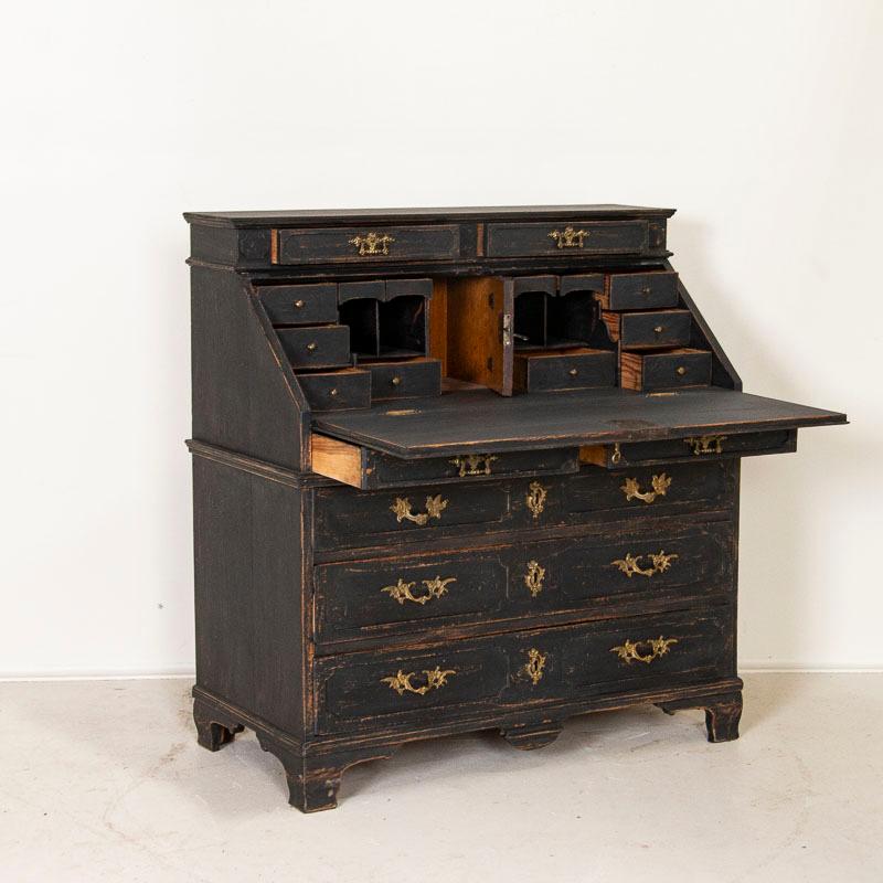 This oak secretary reflects the refined grace and style of early 1800s, Sweden. The paneling along the drawers and unique crown of 2 drawers at the top set this bureau apart from others. The traditional interior has 8 unique, small drawers offering