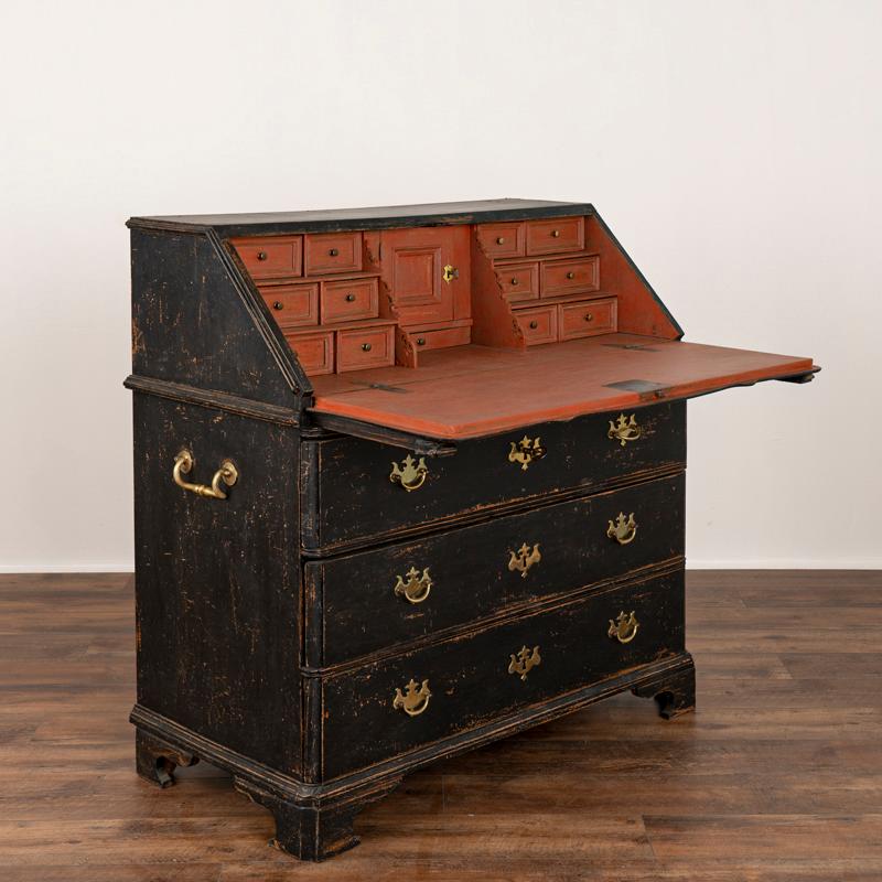 This oak secretary reflects the refined grace and style of early 1800's Sweden. The applied decorative carving adds a romantic touch to the drop down desk. The traditional interior has 13 unique, small drawers offering space to organize and a