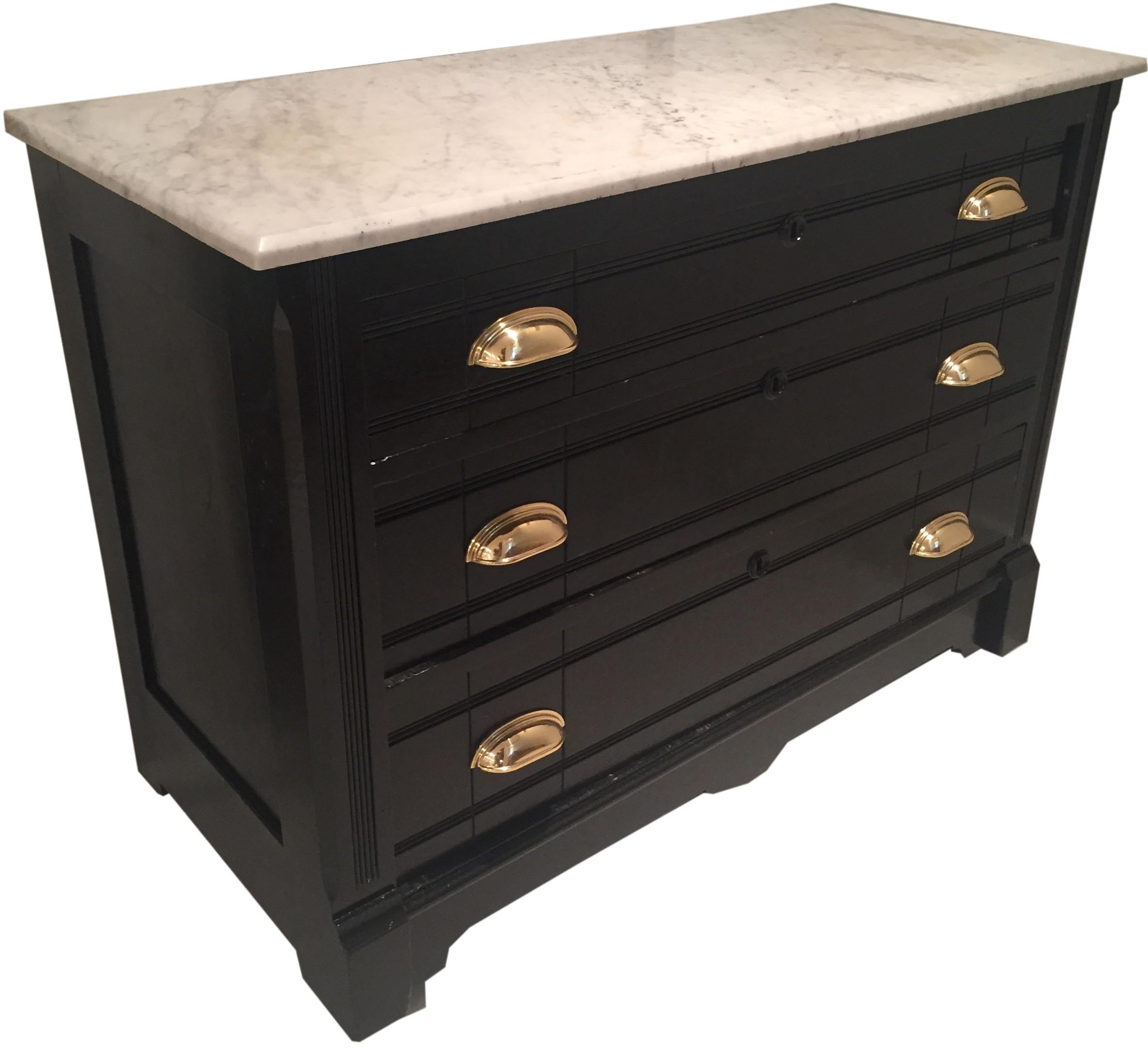 Antique black painted Victorian commode/ chest of drawers with marble top. The piece has been painted with semi gloss paint and new brass hardware added to freshen this adorable chest!