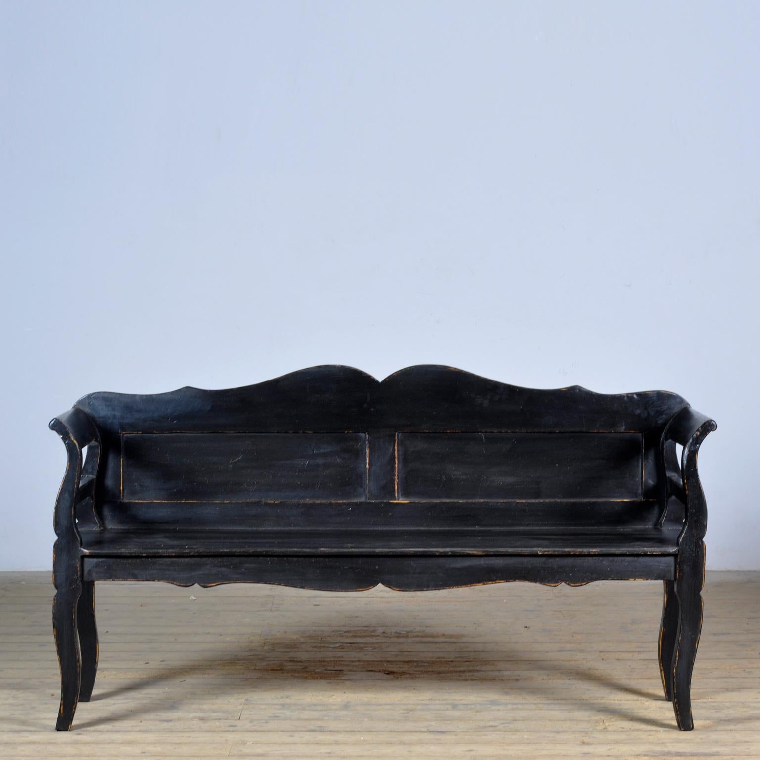 A charming bench from hungary with the original paint. Over time and use, the black paint has been worn away in places to the wood. The bench is stable and sturdy. Free of woodworm.