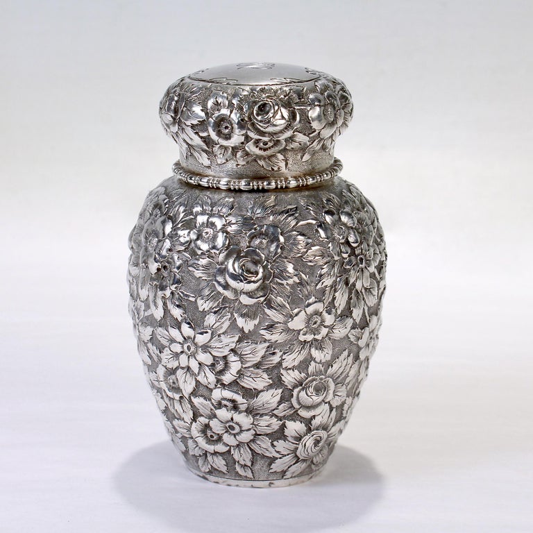 A fine antique sterling silver tea caddy.

By Black, Starr, & Frost.

Decorated throughout the body and lid with repousse flowers. 

The lid is monogrammed with an 'MC'.

Simply a great tea caddy! 

Date:
Late 19th or Early 20th Century

Overall