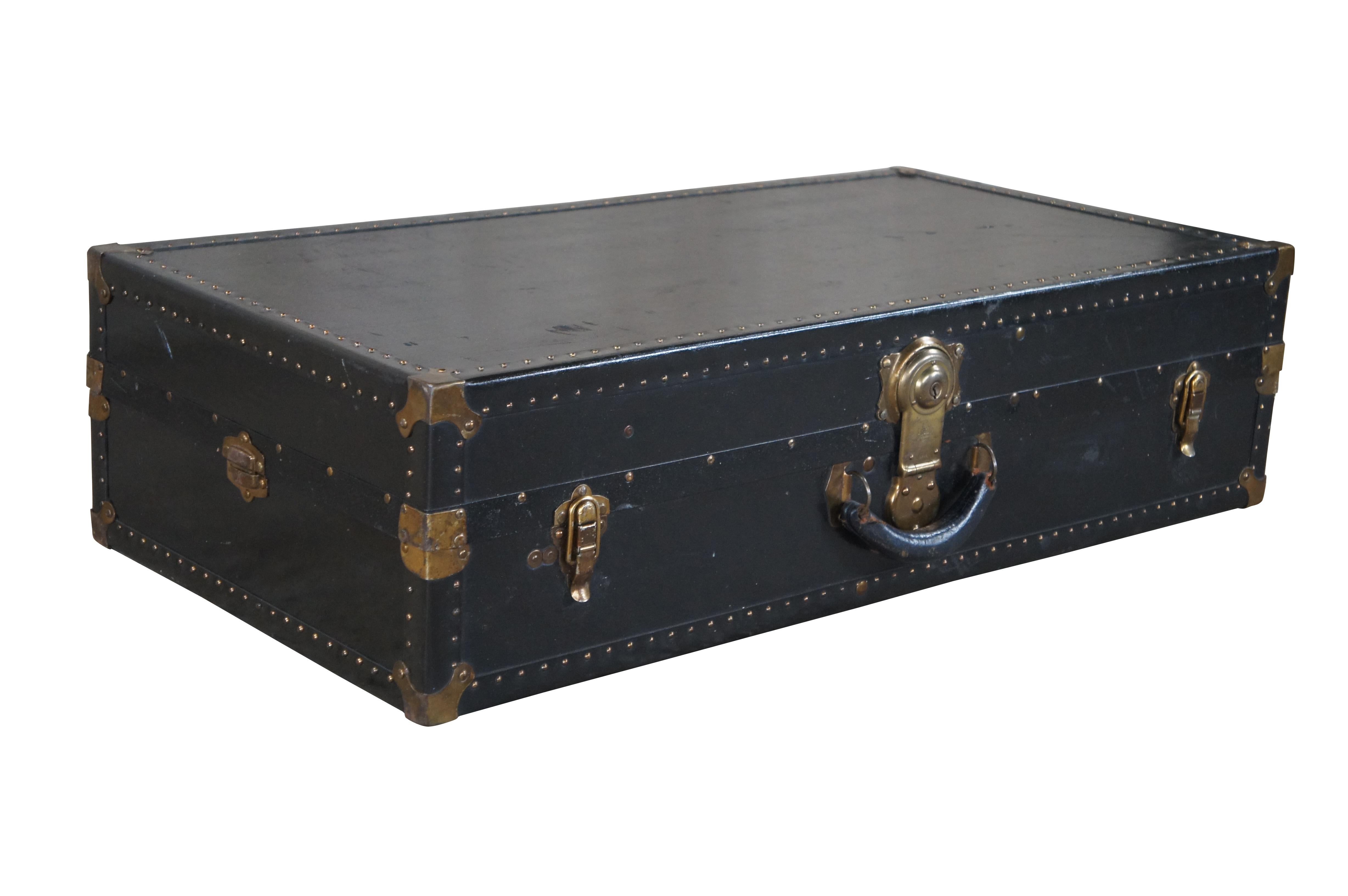 Antique Excelsior wardrobe steamer trunk / suitcase / travel case featuring black exterior with nailhead trim and brass hardware.  Opens to original blue interior with hanging rack and hangers, a drop down compartment / drawer, and removable case. 