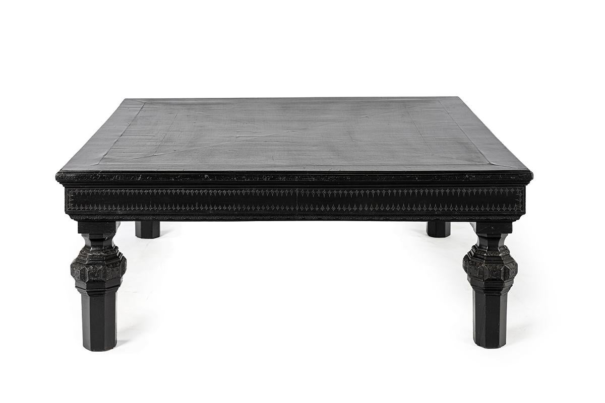 This rare square coffee table was crafted in France around 1880. The piece is made of ebonized walnut: the top is finely veneered in walnut, while the frame and legs are executed in solid walnut. The deep black finish enhances the strong