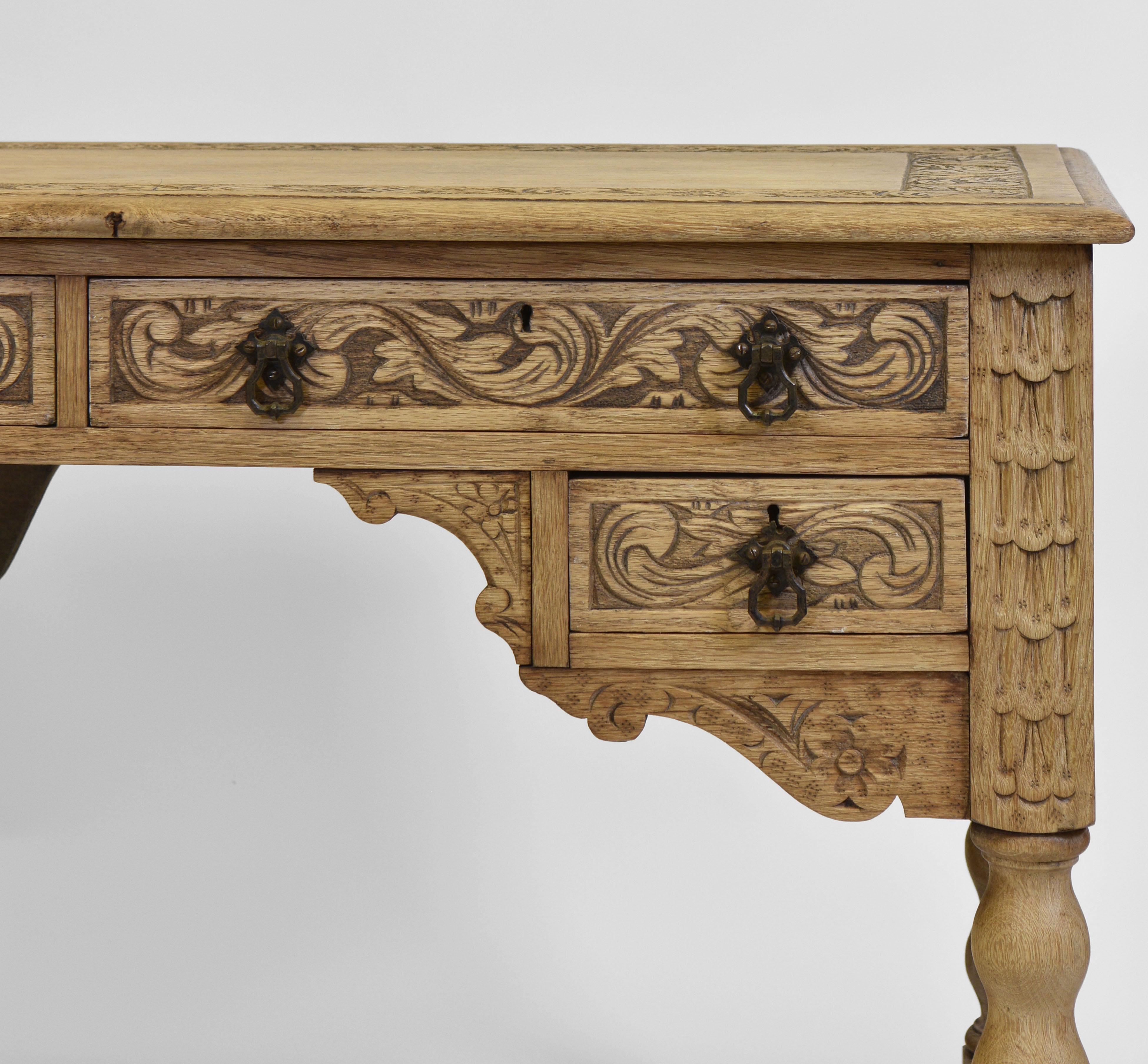 An antique bleached carved solid oak four drawer kneehole desk by Hewetson, Milner & Thexton Ltd - Tottenham Court Road London. Circa 1900. Labelled.

The bleached desk has been given a very light water based finish to add depth. It has the original