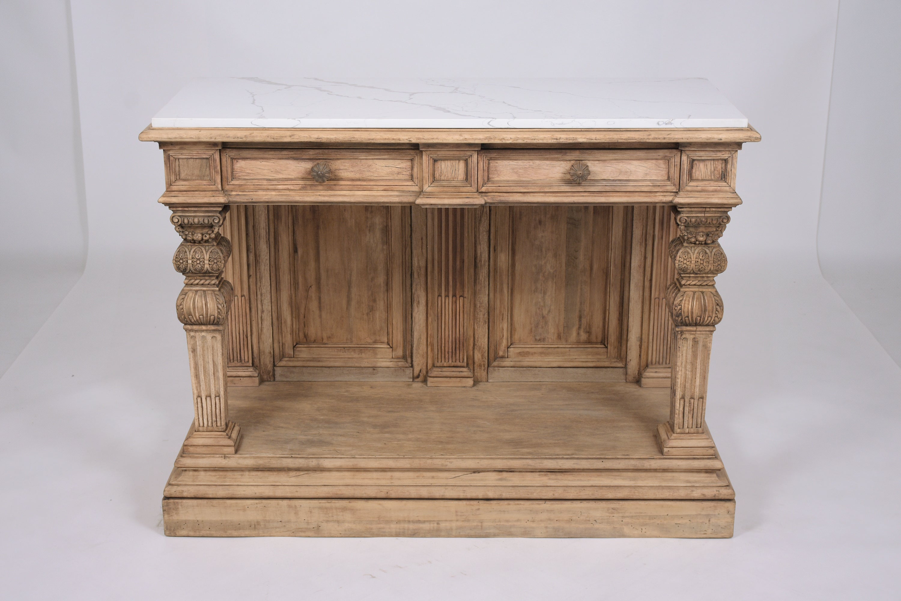 An extraordinary antique baroque carved console beautifully crafted out of walnut wood in great condition and completely restored by our craftsmen team. This server features a white marble with grey vines marble top, a unique bleached wood finish