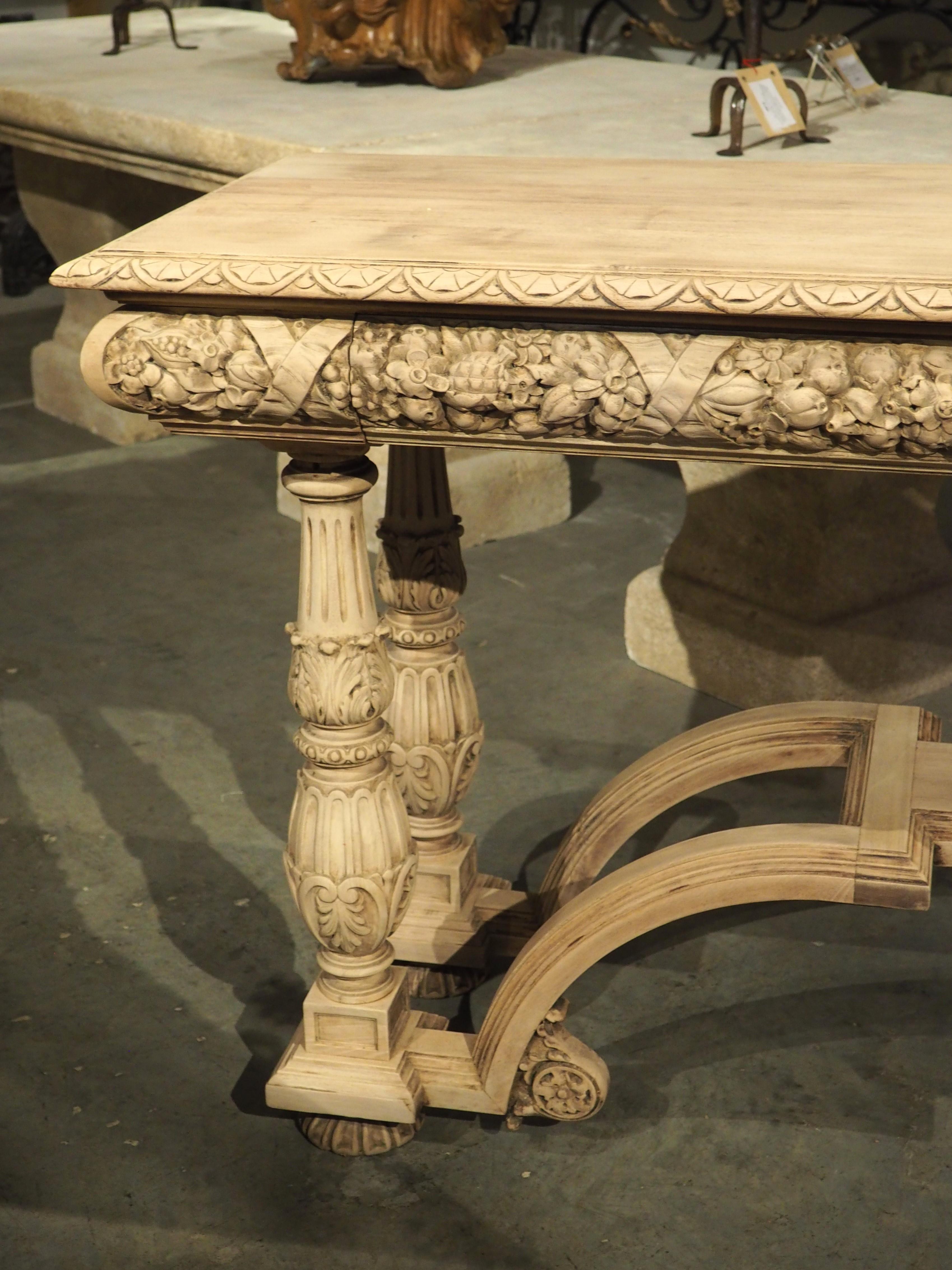 At over six feet wide and three feet tall, this walnut console table has a commanding presence. Hand-carved in France during the late 1800s, the wood has been bleached more recently, resulting in a very pleasing beige color that accentuates the