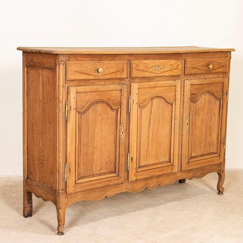 It is the arched paneled doors, scalloped skirt and diamond detail of the drawers that separate this French oak sideboard apart from others. The bleached finish gives it a fresh and welcoming look for today's modern home and shows off the wonderful