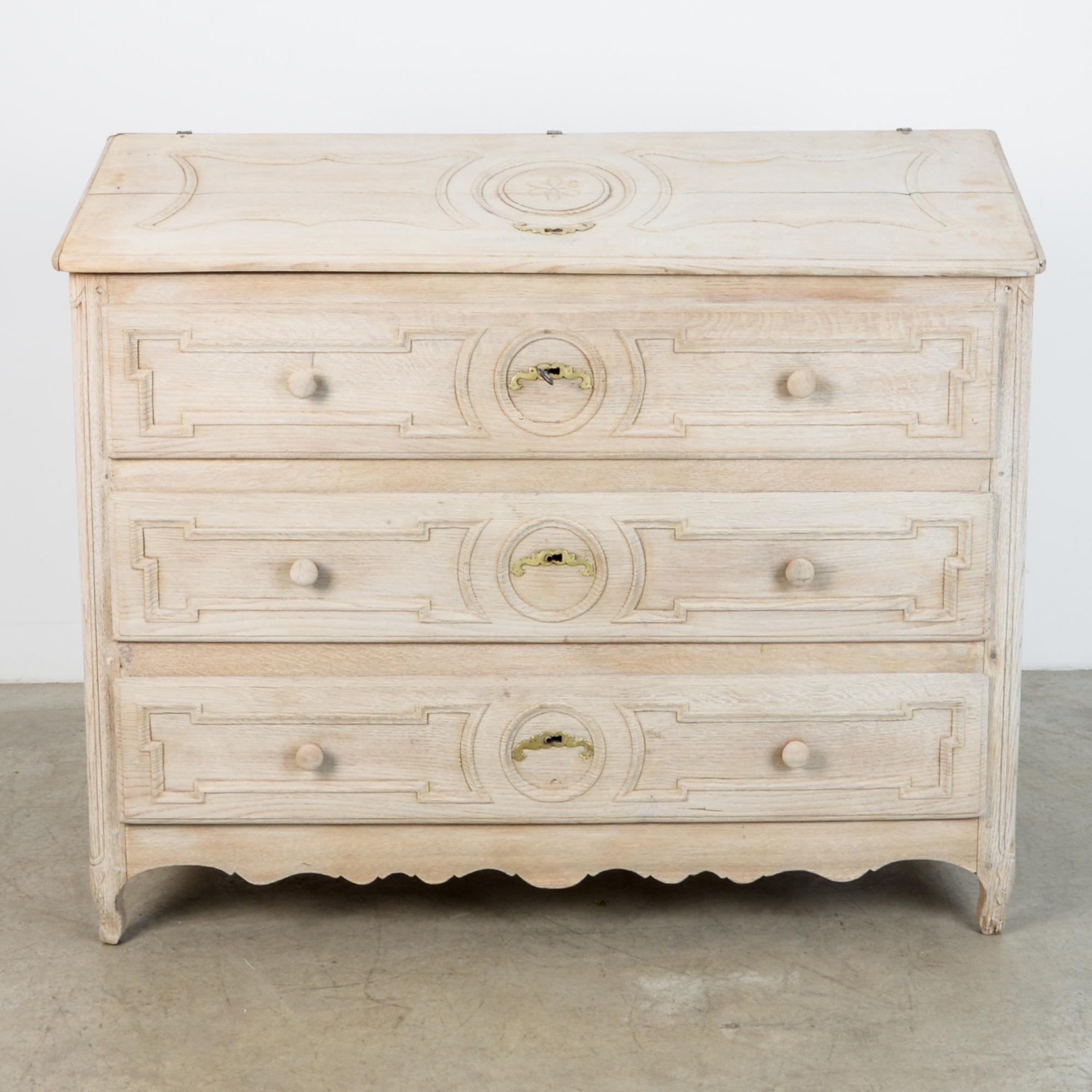 From France circa 1860 this three drawer cabinet is topped with a locked upper panel, originally fitted with a folding writing desk. Bleached oak finish gives this cabinet a bright and contemporary presentation, while highlighting the craftsmanship,