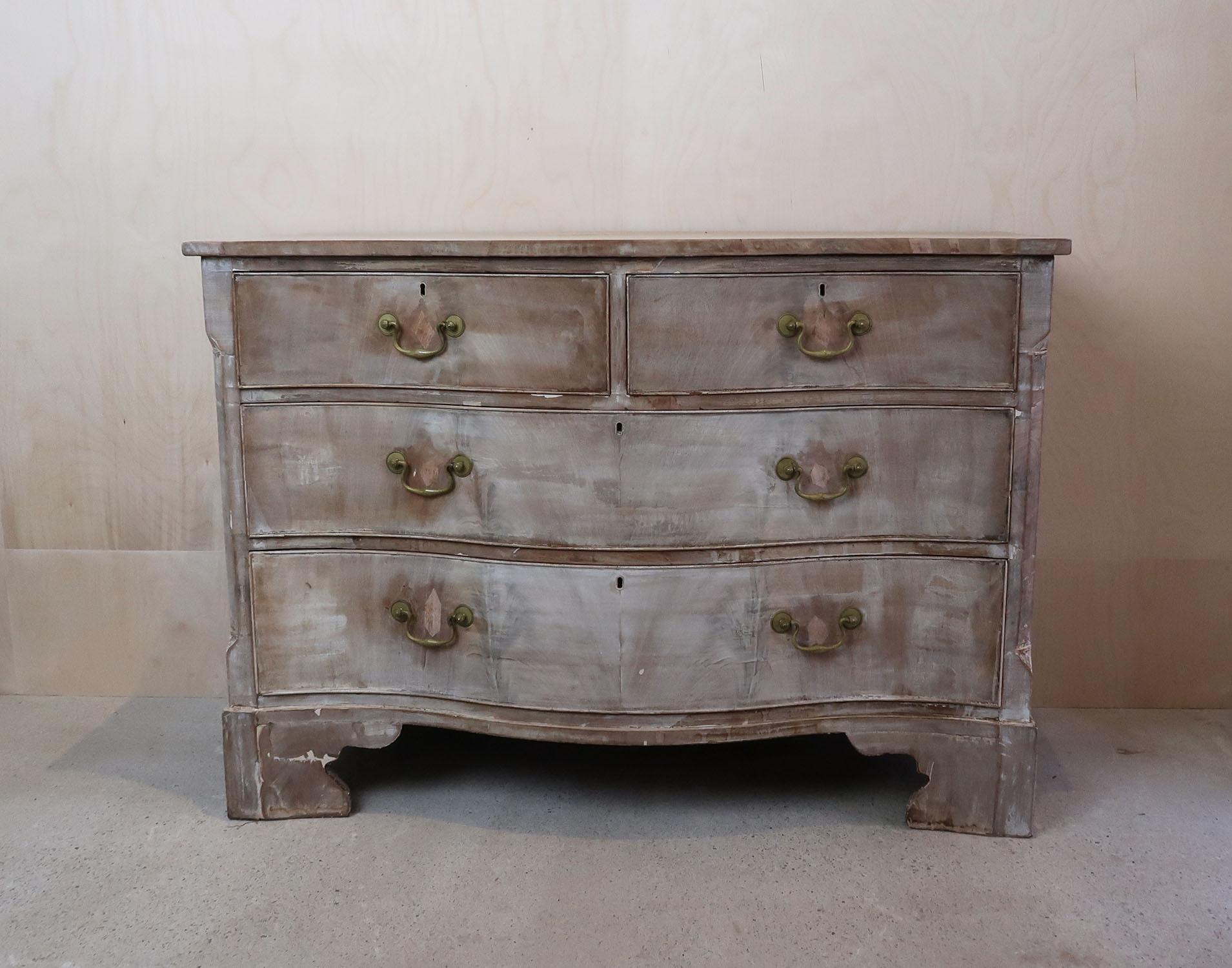 Wonderful characterful commode or chest of drawers.

Bleached tropical hardwood.

Lovely shaped serpentine front

Veneered drawer fronts.

Original bracket feet

Later brass swan-kneck hardware.




