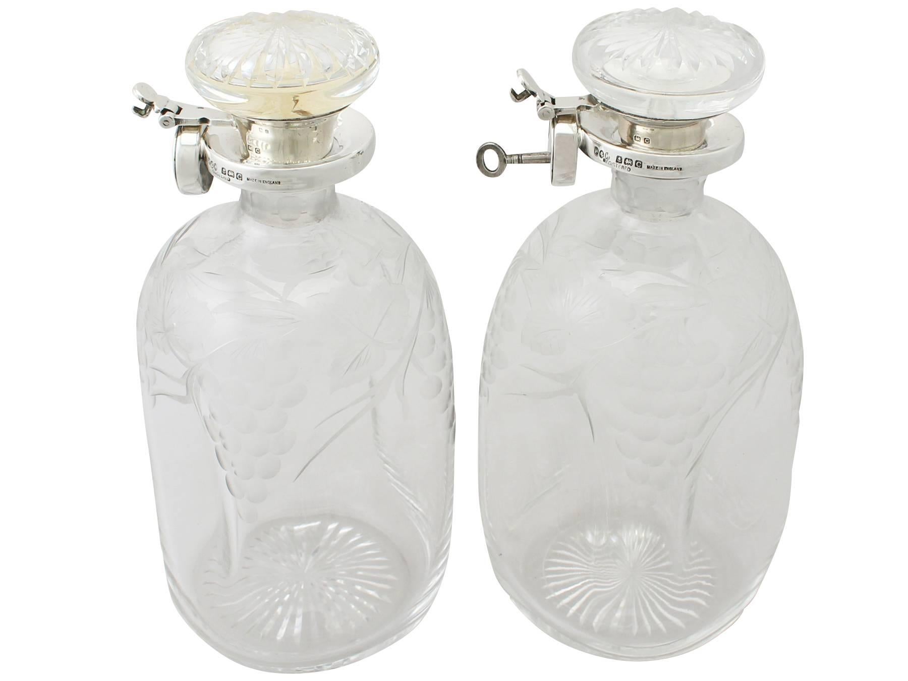 An exceptional, fine and impressive pair of antique George V blown and acid etched glass, English sterling silver mounted locking decanters made by Hukin & Heath Ltd, an addition to our wine related silverware collection.

These exceptional