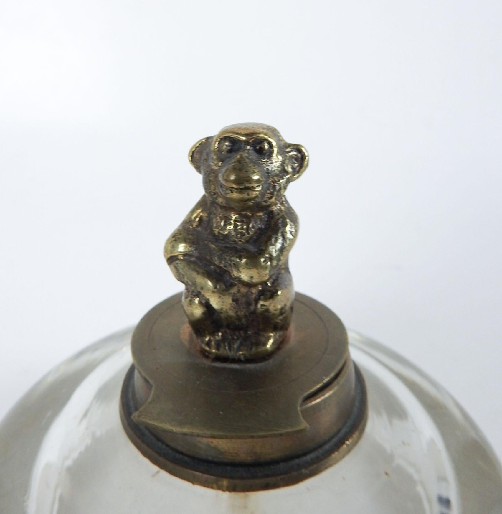 Antique blown heavy glass inkwell with cast brass or bronze monkey on lid.  Nice and heavy, wear to bottom, overall patina to brass.  4