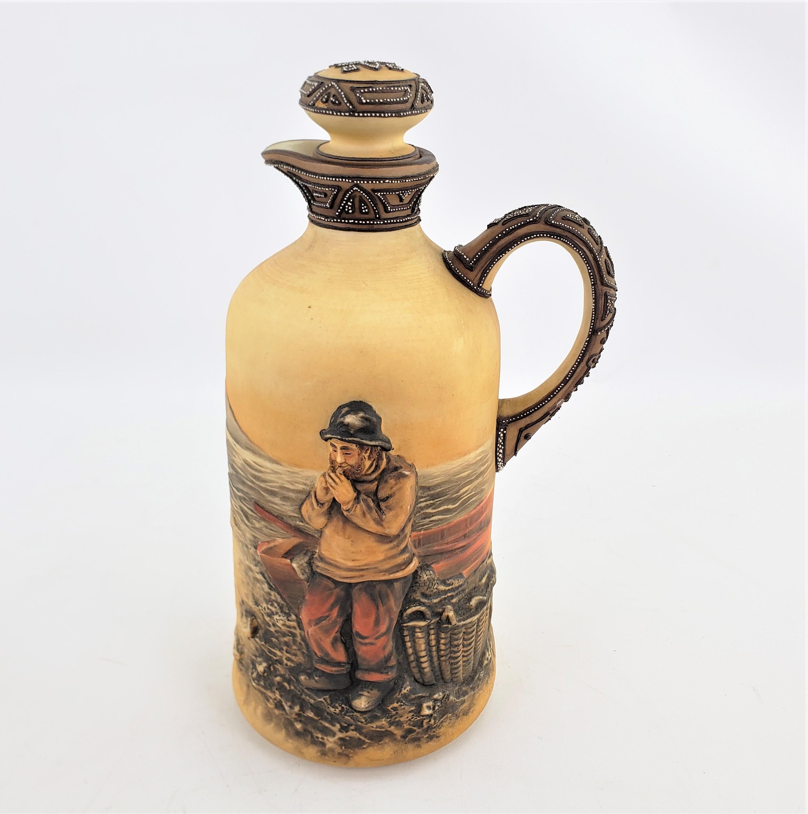 This antique porcelain decanter or jug was made by the renowned Nippon factory of Japan in approximately 1920 and done in the period Art Deco style. The decanter is done with a molded white porcelain which has been hand-painted. The entire decanter