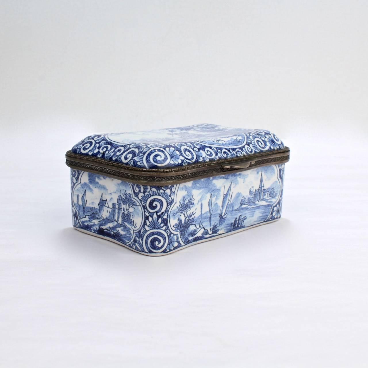 A fine, antique Delft pottery table snuff box.

With blue and white scrollwork decoration surrounding the cartouches on each panel.

The base bears a blue factory mark.

Measures: width ca. 4 in.

Items purchased from this dealer must