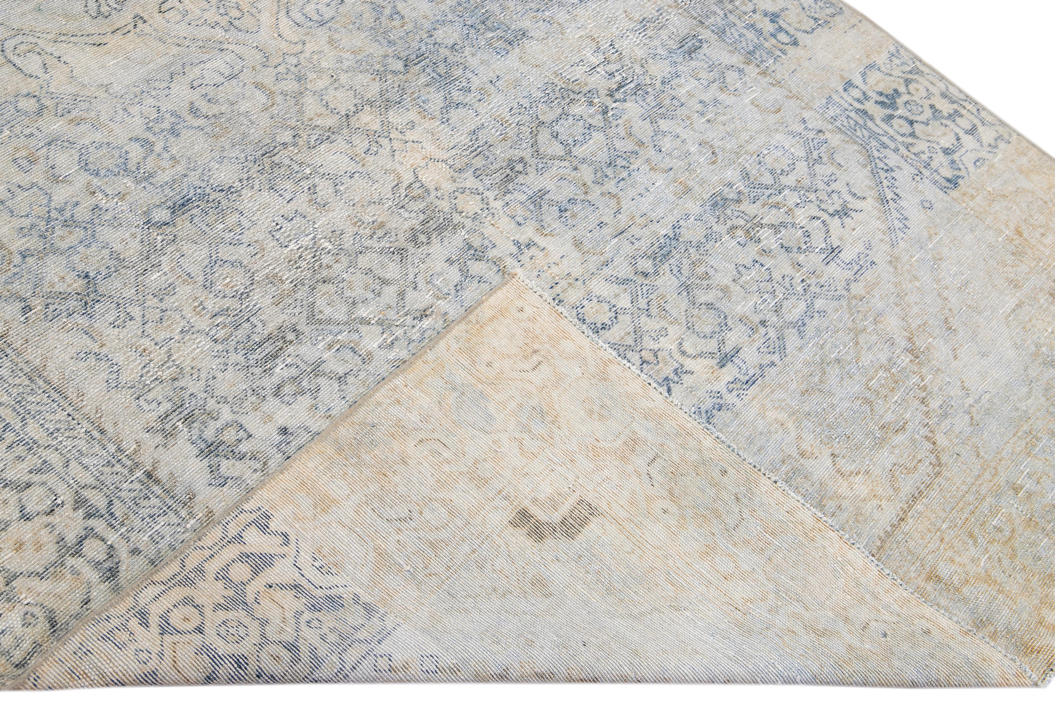 Beautiful hand-knotted antique Mahal wool rug with the Beige field. This Persian rug has blue accents featuring a traditional medallion floral design. 

This rug measures 5'4