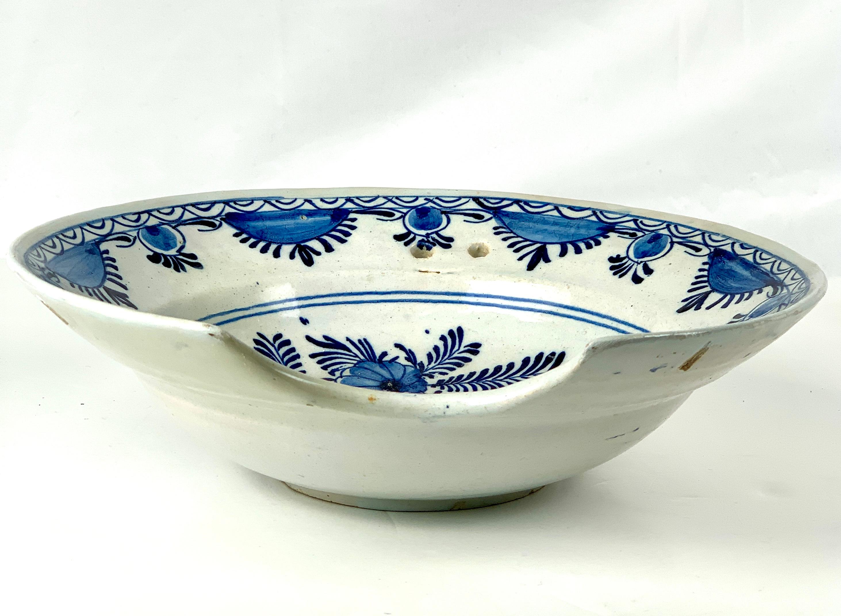 This blue and white Dutch Delft barber's bowl (scheerbekken) is a beautiful and fascinating artifact that provides insight into the history of barbers in the late 18th century (circa 1780) and the decorative arts of the Dutch during this period.
The