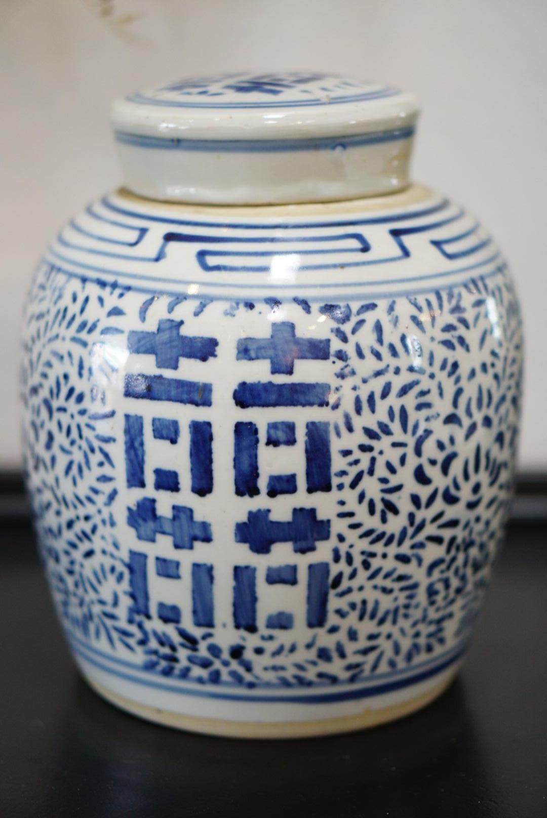 offered is a classic Chinese blue and white porcelain ginger jar. Hand painted in rich cobalt blue with large Chinese double happiness characters and intricate scrolling floral and foliate patterns. It is in excellent condition for it's age.  
