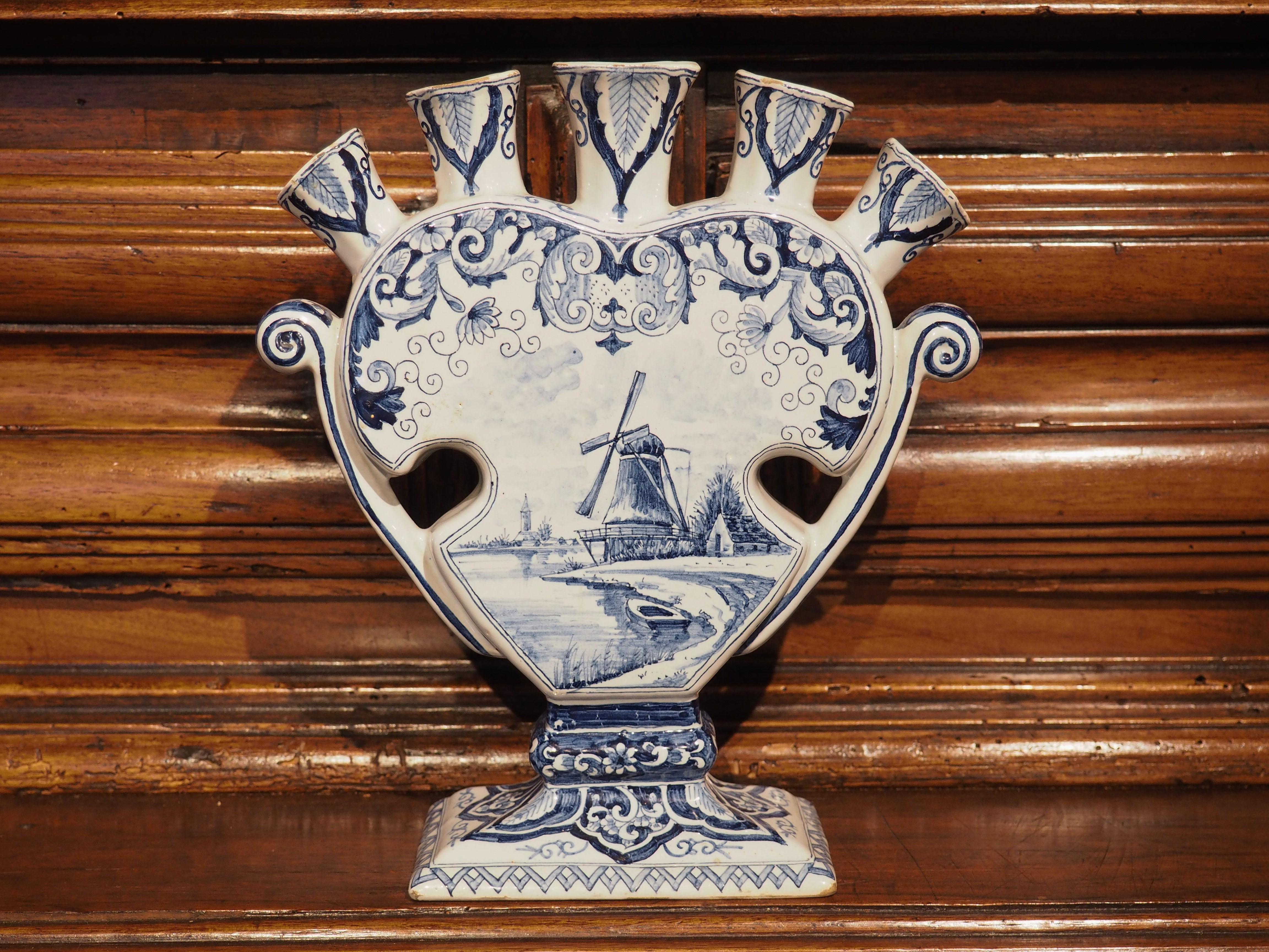 This blue and white Delftware urn is known as a tulip vase, as it was designed to hold cut flowers, specifically tulips, which are strongly associated with the Netherlands. The quintal vase (meaning it has five 