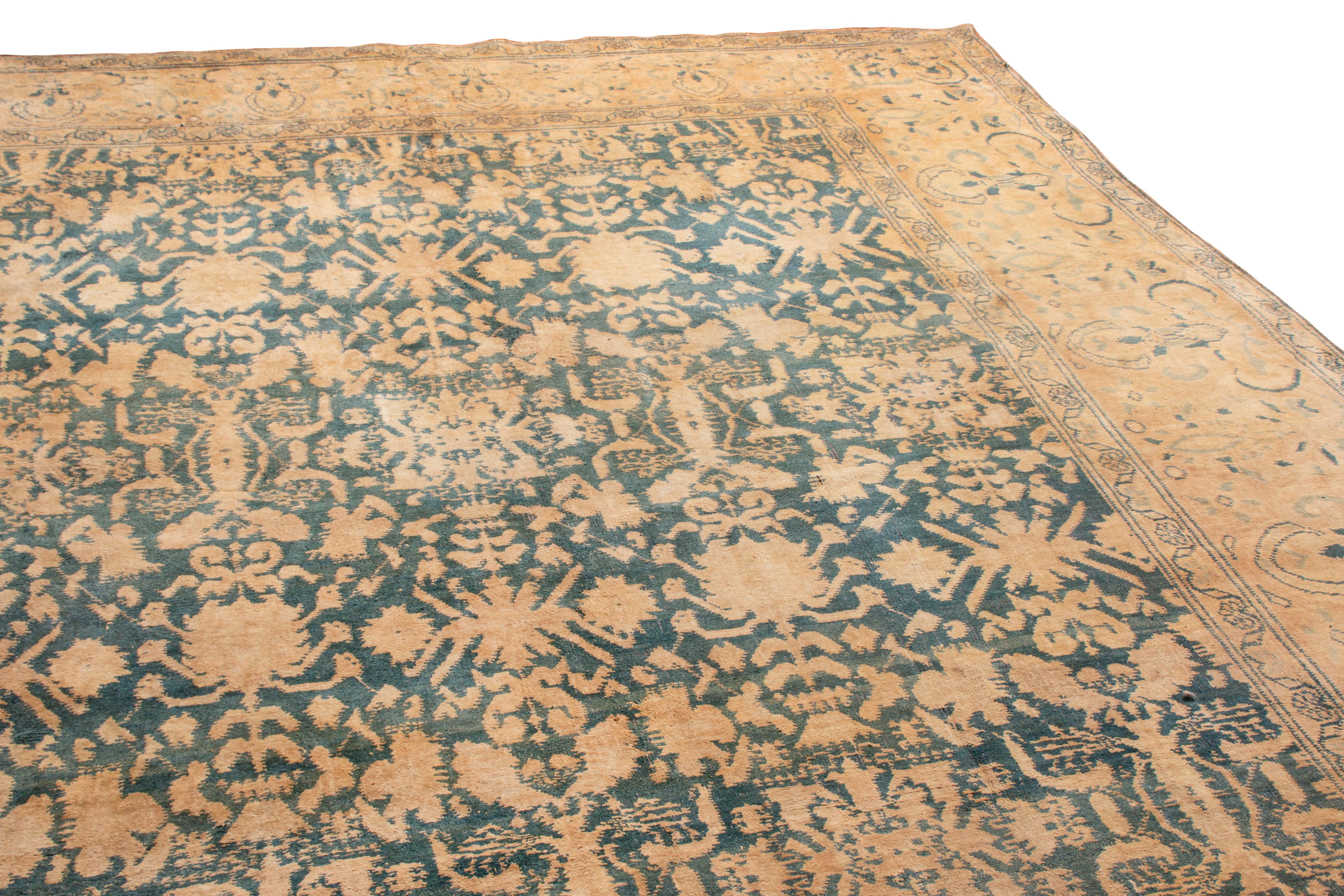 This antique traditional Indian rug has a geometric-floral pattern in cotton weave. From 1920, the maharajahs of India would typically use this in their homes in the summertime. The cotton Agra is extremely durable against distress, as shown in the