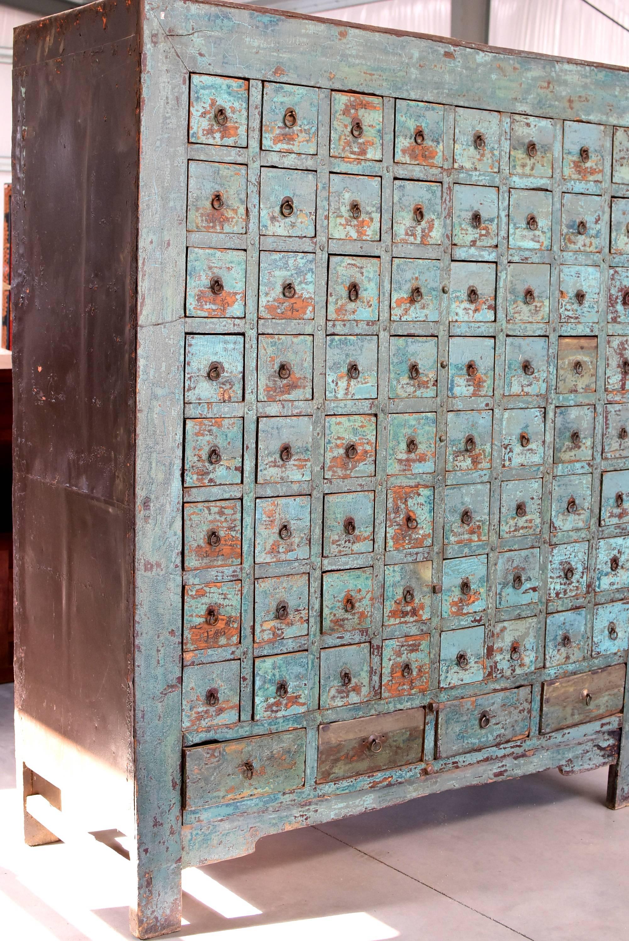 Beautiful, rare, blue colored apothecary cabinet is one of a kind and very special. 68 drawers are adorned with original iron and coin hardware. 64 of them have three internal dividers while four large drawers have two or four dividers. They offer