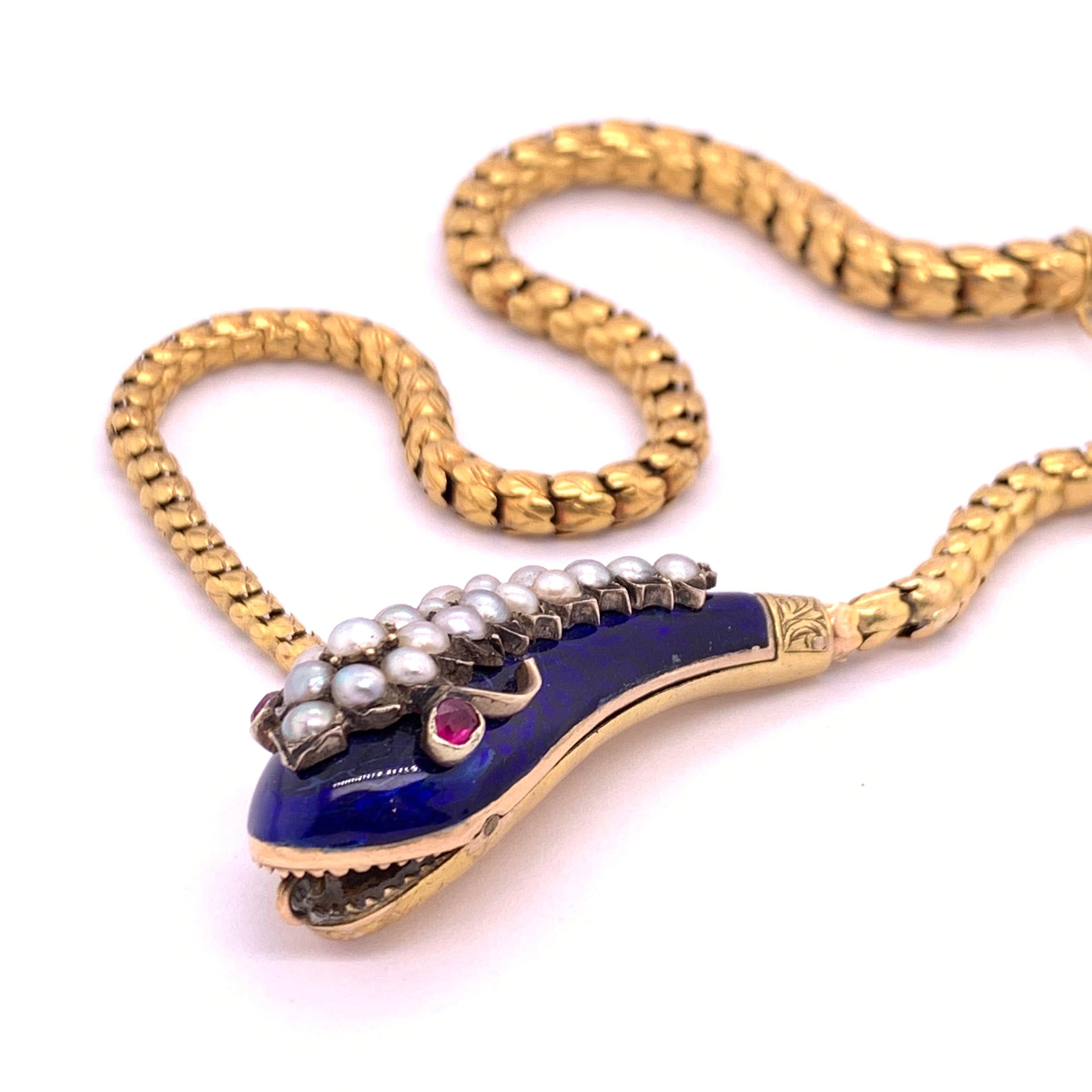 Antique snake necklace with a blue enamelled head, set with natural half pearls and rubies with a body made up of gold scales. In Victorian symbolism the snake biting its tail symbolized eternal love. Circa 1850 to 1860.