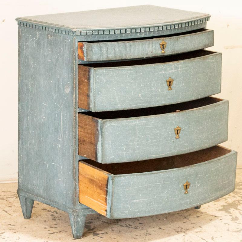 It is the wonderful, aged blue paint that draws one to this lovely chest of drawers from Denmark. The softly curved front adds a touch of grace, accented by the traditional dentil molding and carved top drawer. This item is part of our “un-restored”