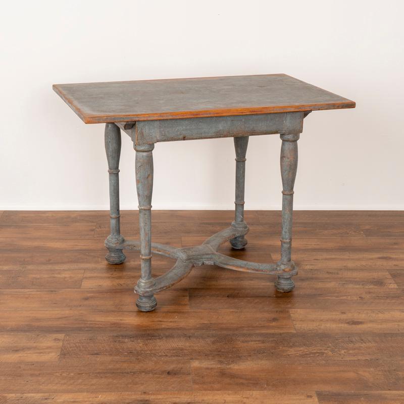This delightful side table is a wonderful example of Swedish country craftsmanship of the early 1800's. The turned legs with X stretcher base resting on bun feet are traditional style elements. What makes this table special is the captivating color,