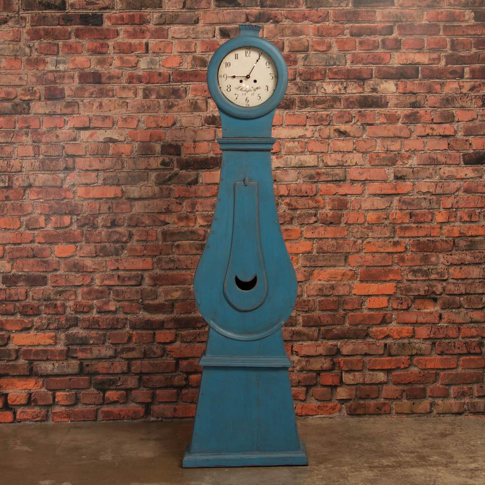 Graceful curves and remarkable craftsmanship accentuate this striking antique grandfather clock from Sweden with distressed blue paint, circa 1850. Please examine the close up photos to appreciate the painted finish which compliments the Swedish
