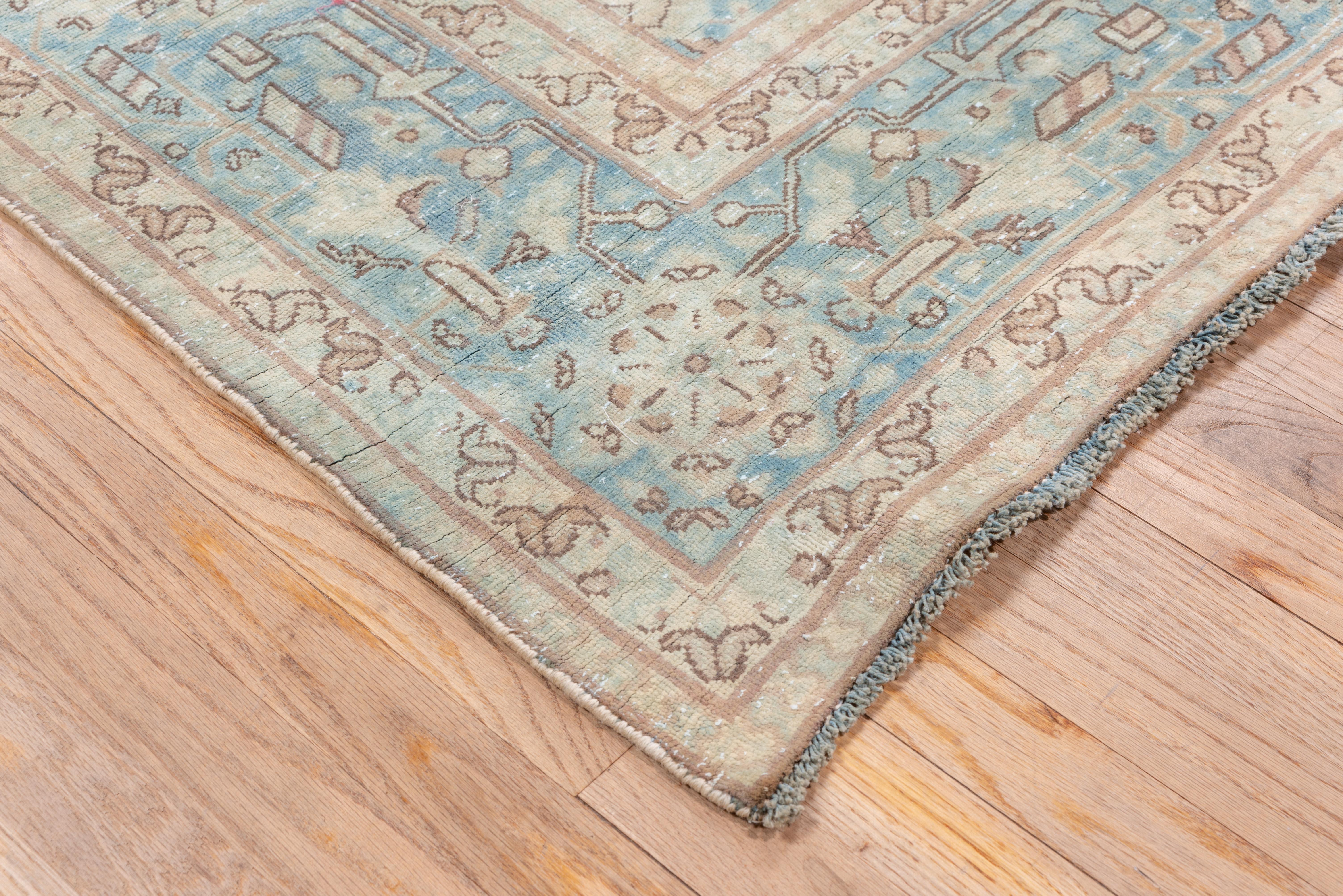 This light blue persian Kerman rug has a Powder blue field with an allover pattern of octofoil stars and rosette-guls, Pale blue border with complex rosettes and stiff stems. General even wear, fairly good condition, Well-woven NW Persian city
