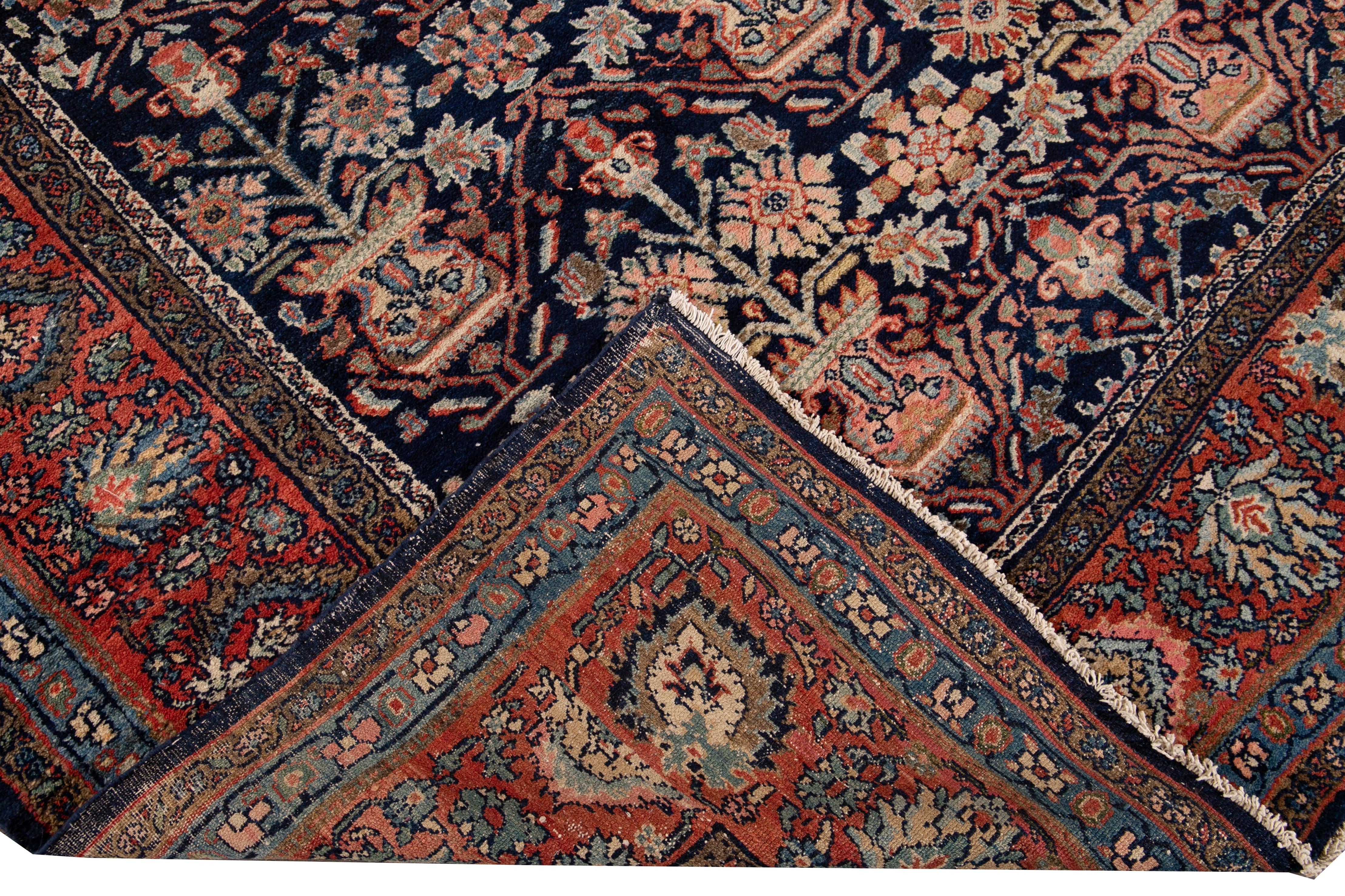 Beautiful vintage Persian Malayer hand knotted wool rug with a blue field. This Malayer rug has a red frame and multi-color accents in an all-over geometric Botanical design.

This rug measures: 9'3