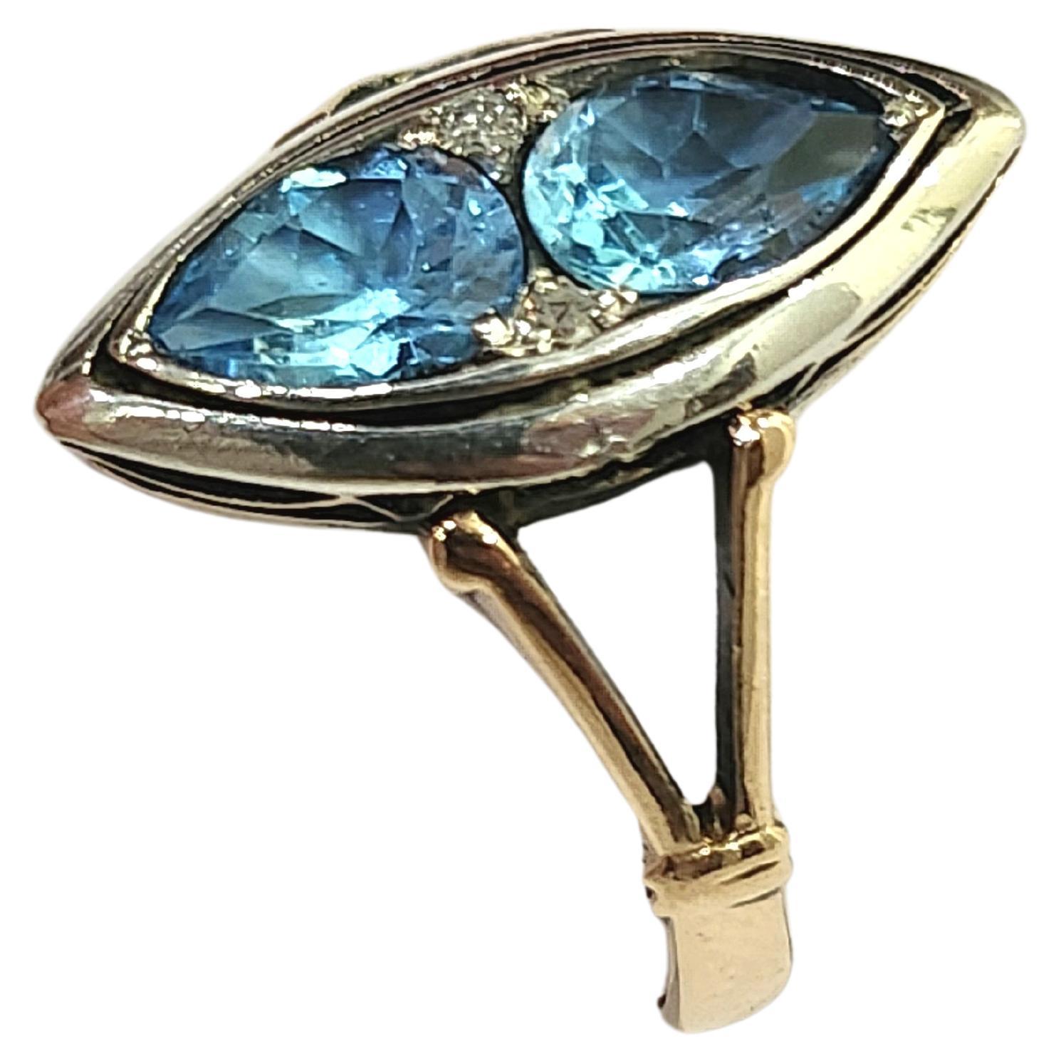 Antique artdeco era ring centered with 2 blue topaz stones in pear cut shape flanked with little diamonds in 14k gold setting topped with silver dates back to 1930s