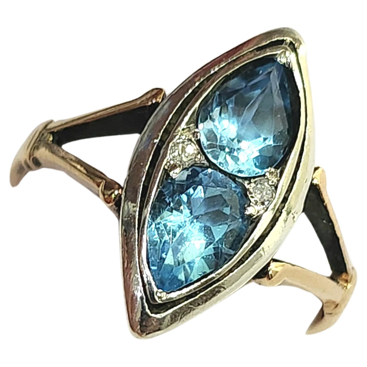 Antique artdeco era ring centered with 2 blue topaz stones in pear cut shape flanked with little diamonds in 14k gold setting topped with silver dates back to 1930s