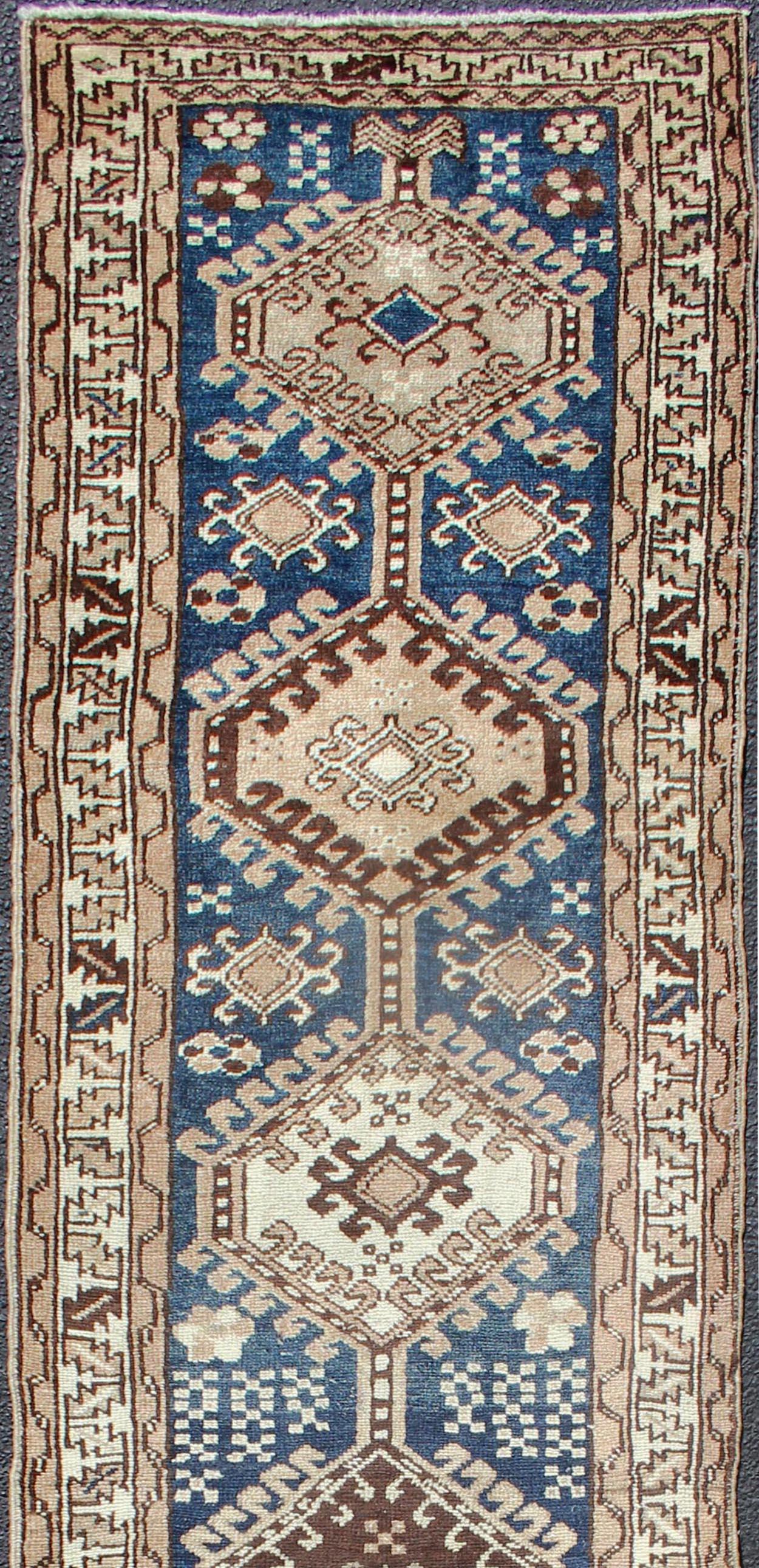 Antique Persian Karajeh runner with stacked medallion in taupe, cream, blue, rug PRM-M522, country of origin / type: Iran / Karajeh, circa 1920

This antique Persian karajeh runner from early 20th century Iran features a vertical arrangement of