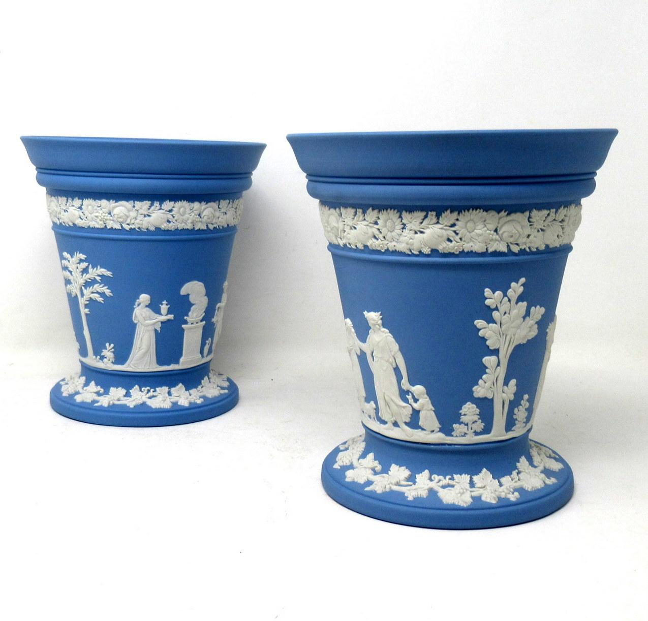 An exceptionally fine example of a pair of English blue jasper ware Wedgwood flower vases of good size proportions and outstanding heavy gauge quality, complete with their original flower receptacles. Mid century, dated 1960s.

Of trumpet form