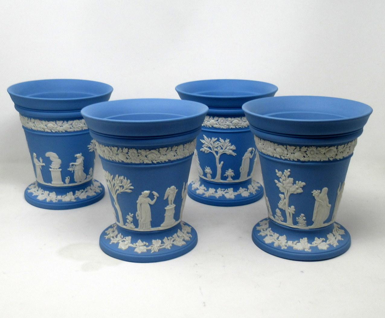 An exceptionally fine example of a seldon seen set of Four English blue jasper ware Wedgwood flower vases of good size proportions and outstanding heavy gauge quality, complete with their original flower receptacles. Midcentury, dated 1960s.

Of