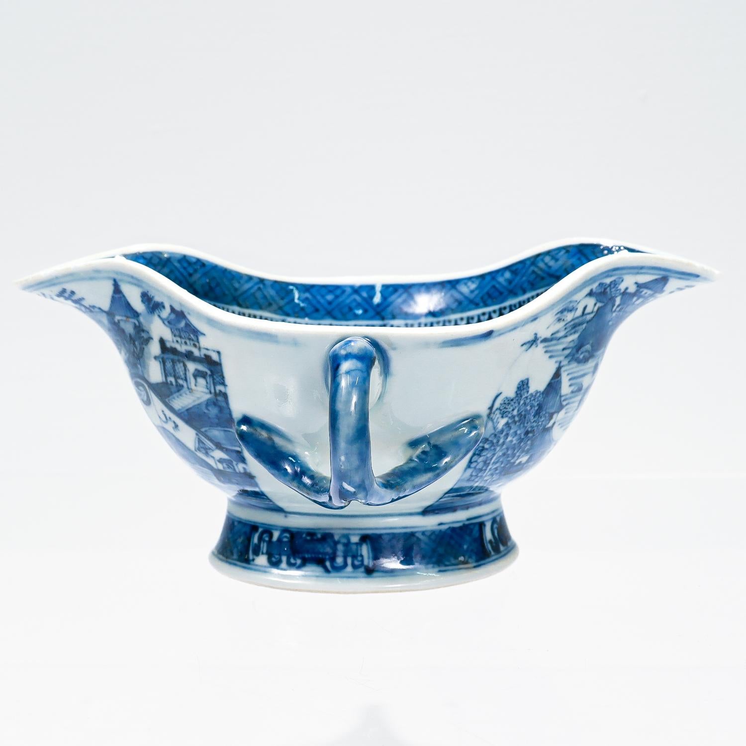 A fine antique Chinese export porcelain gravy boat.

In the Nanking pattern. 

Decorated in underglaze blue.

With a trellis-diaper border to the interior rim surrounded with spearheads and dumb-bells. The footrim alternates between a trellis