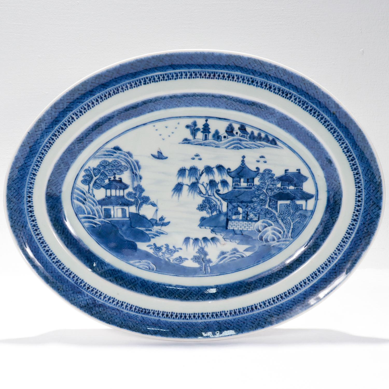 A fine antique Chinese export porcelain serving tray.

In the Nanking pattern. 

Decorated in underglaze blue.

The rim decorated with a trellis-diaper and spearhead & dumb-bells borders and the center with a finely painted Chinese village scene.