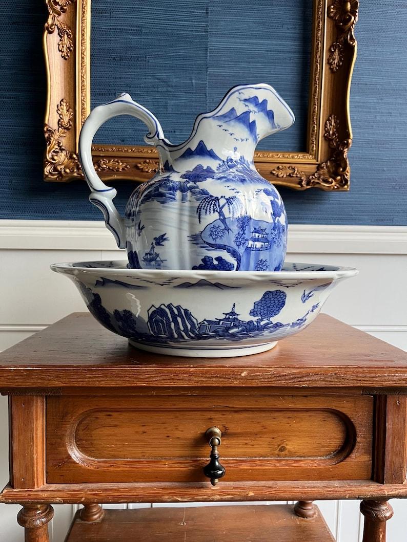 Rooted in centuries of ceramic tradition, this early 20th-century porcelain washstand set draws from the enduring beauty of Canton export ware and the romantic storytelling of Blue Willow patterning. Produced sometime between 1900 and 1920, this