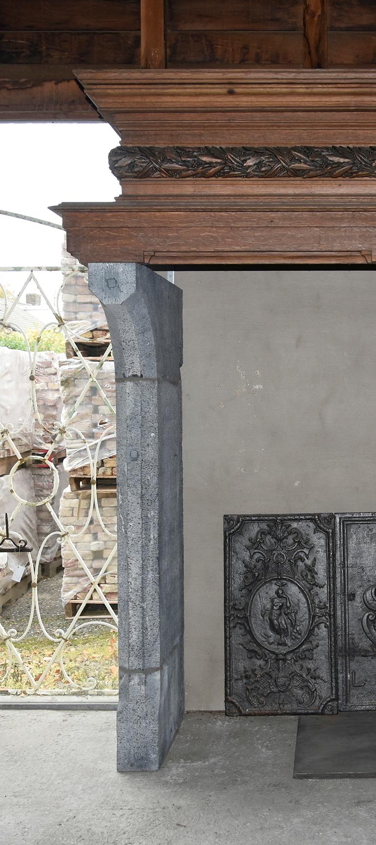 Antique bluestone fireplace mantel with wooden mantel from the 19th century,
from Belgium, to place around the chimney.
