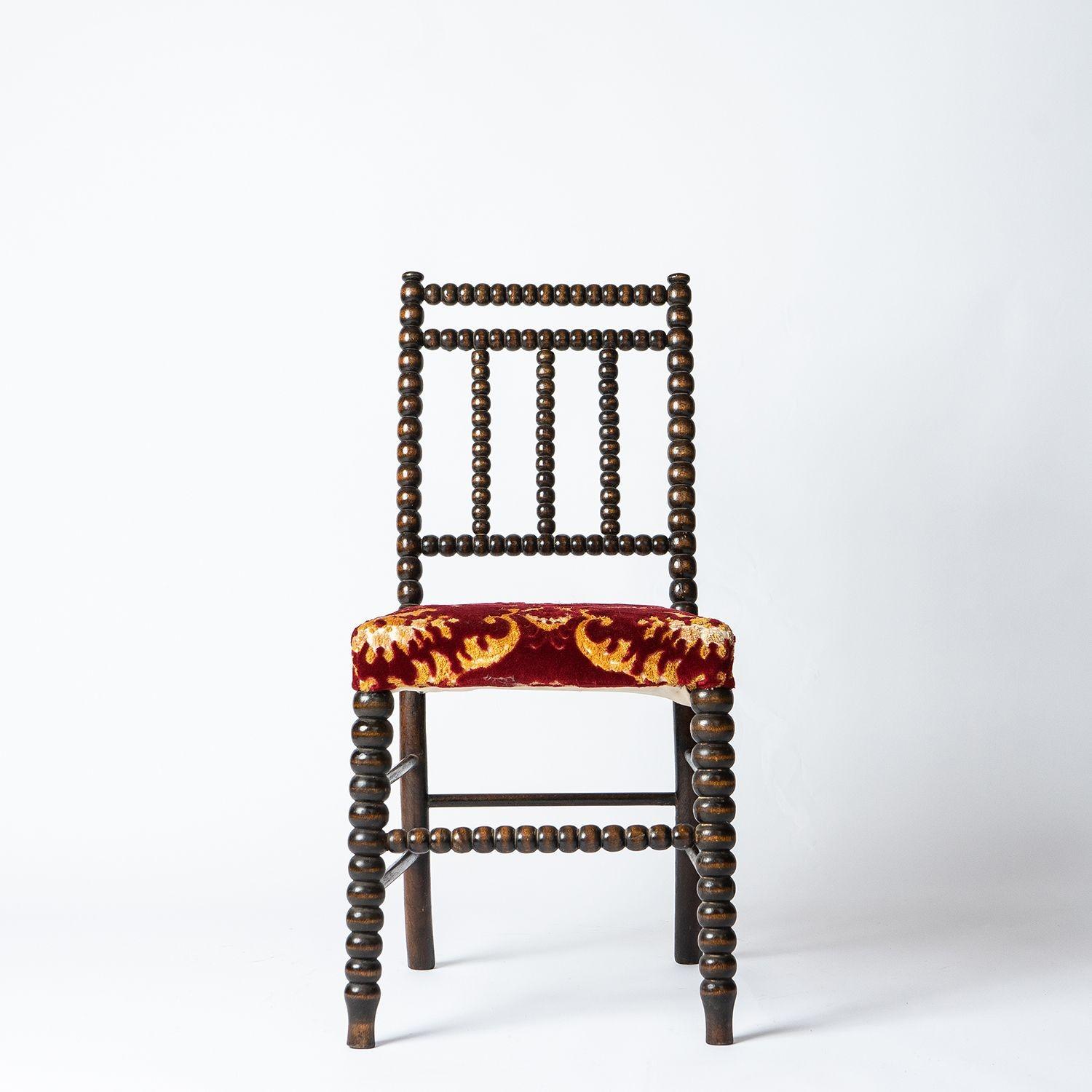 Upholstered occasional chair

An attractive chair of good proportions with bobbin-turned sections and rear sabre legs.
 
Sumptuous red and gold velvet brocade upholstery on the seat.
 
It is in very good vintage condition throughout, it is