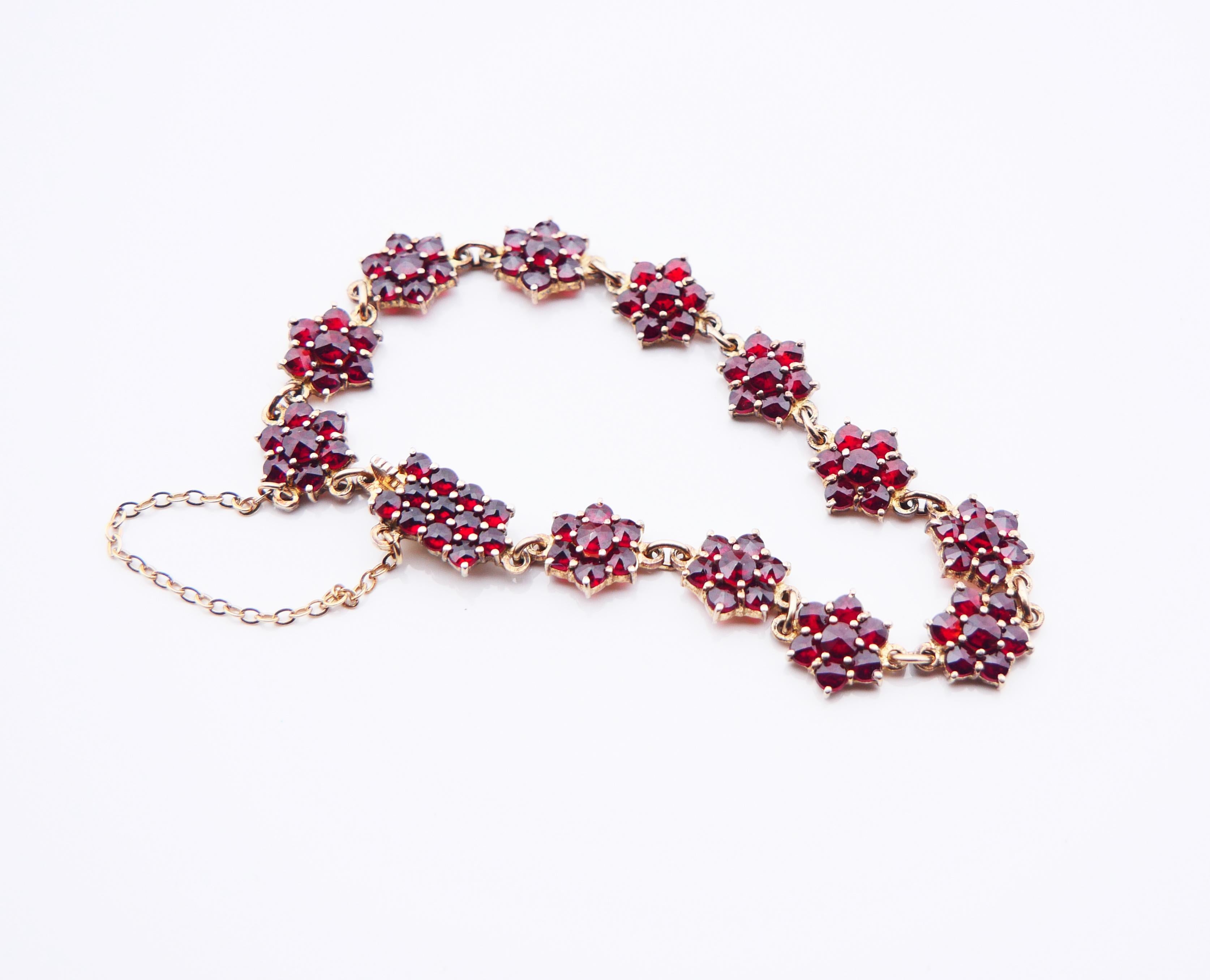 Austrian or Bohemian flexible bracelet with  96 deep red rose cut garnets claw set in florets. Handmade in Central Europe Austria or / Bohemia ca. 1920s - 1930s. Composed of 13 links.

Metal is high grade Silver filled with a thick and wear