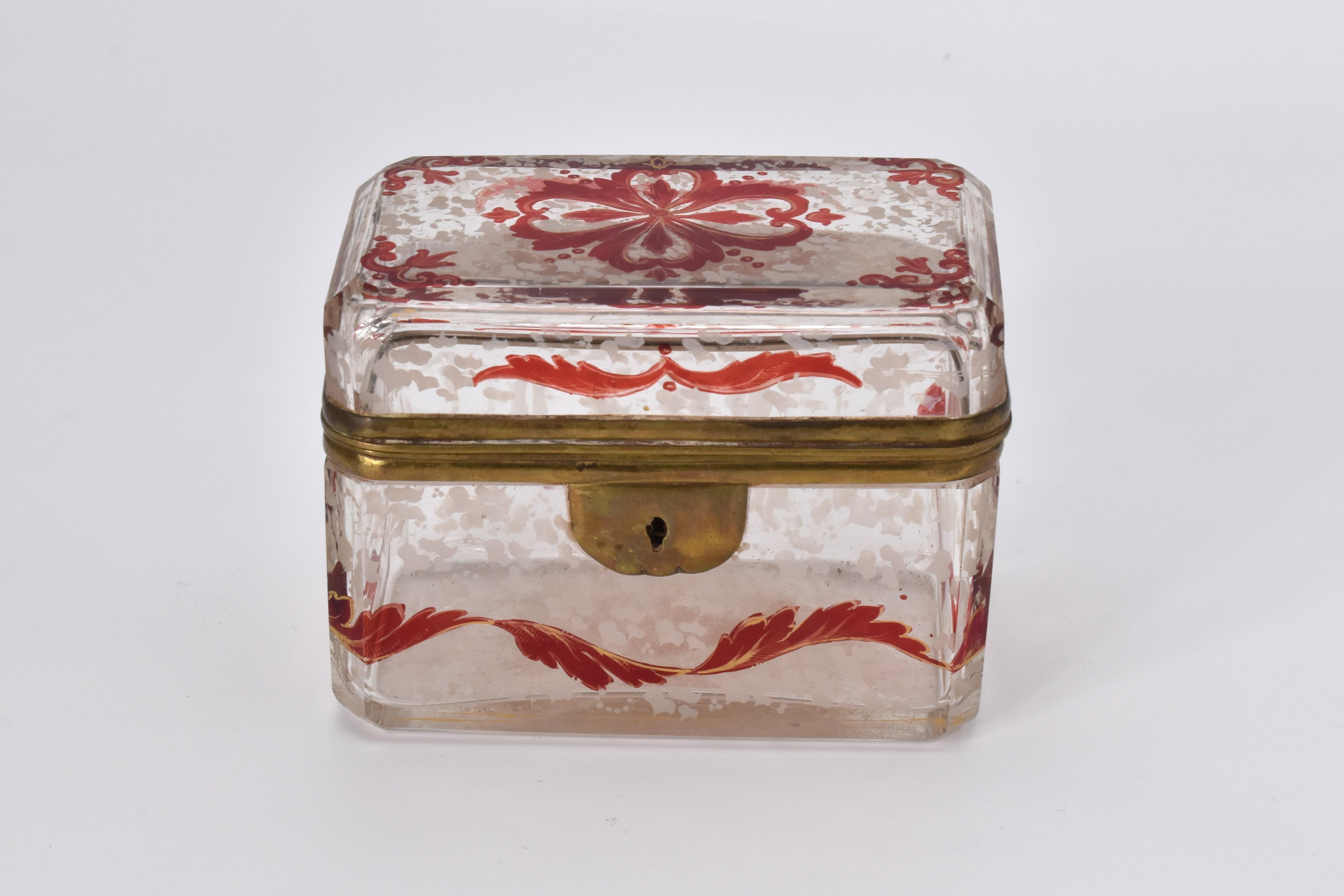 An extraordinary jewelry casket box made of clear glass and hinged metal mounts

with ruby decoration all around with gilded ruby and white enamel and gilding highlights

Bohemia, 1870
