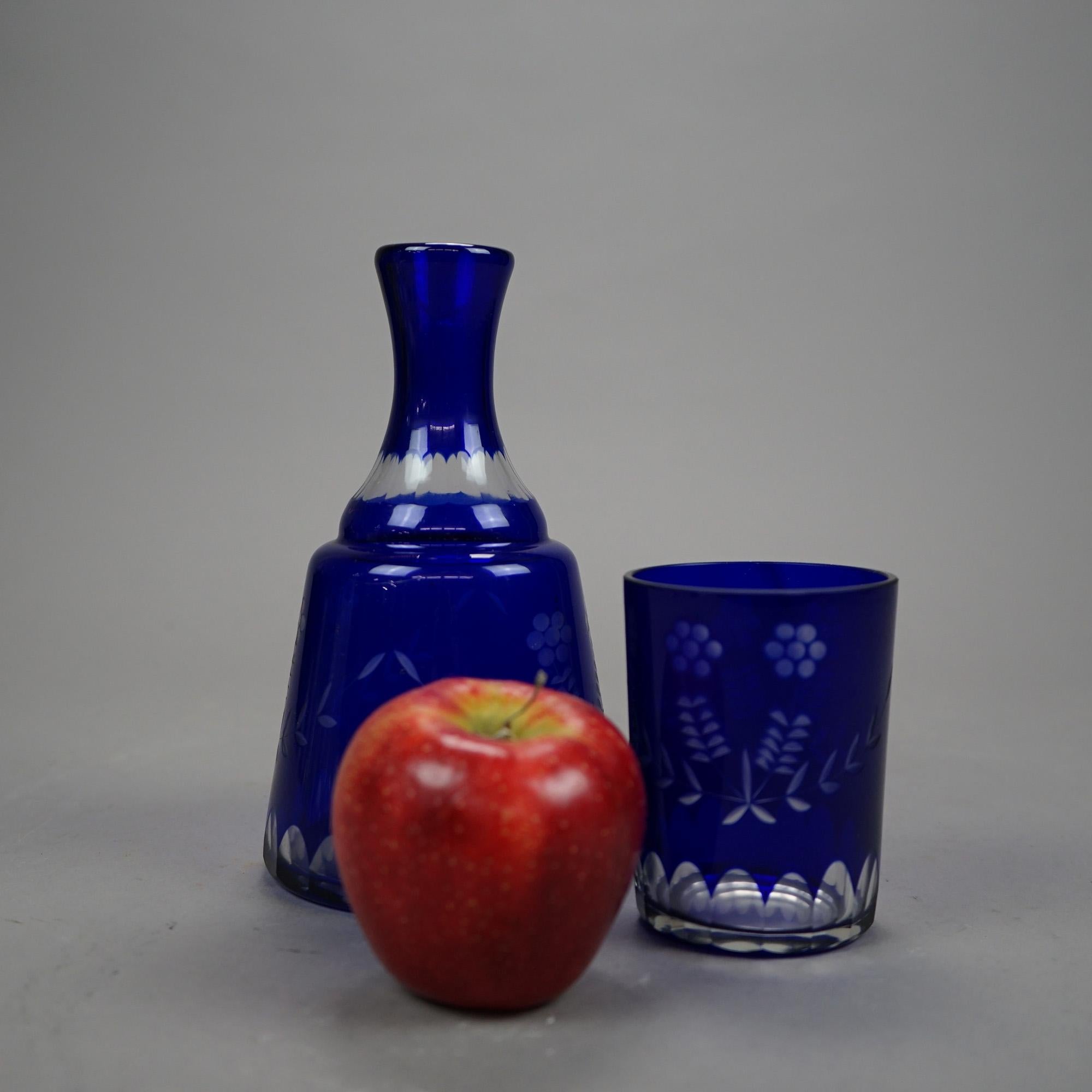 A Bohemian tumble up set offers cobalt cut to clear glass with floral decoration and includes tumbler and glass, circa 1920

Measures - decanter 7.75''H x 4.5''W x 4.5''D; glass 4''H x 3''W x 3''D.
 
Catalogue Note: Ask about DISCOUNTED DELIVERY