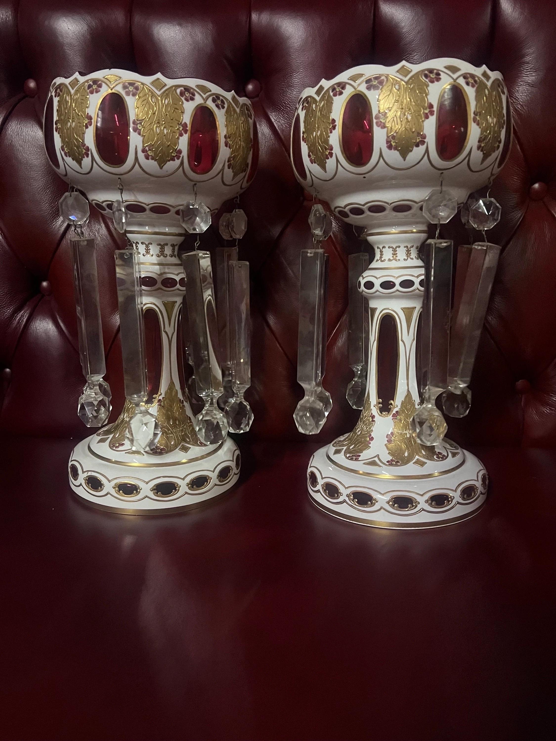 Antique Bohemian Cranberry Glass Candle Lusters - Pair 

Gorgeous Antique Bohemian White Cut to Red Glass Candle Holder, Listers with 8 Hand Cut Crystal Prisms, Hand Painted with Flowers, Foliage and Gilt Scrolls. Truly Spectacular!

Circa 20th