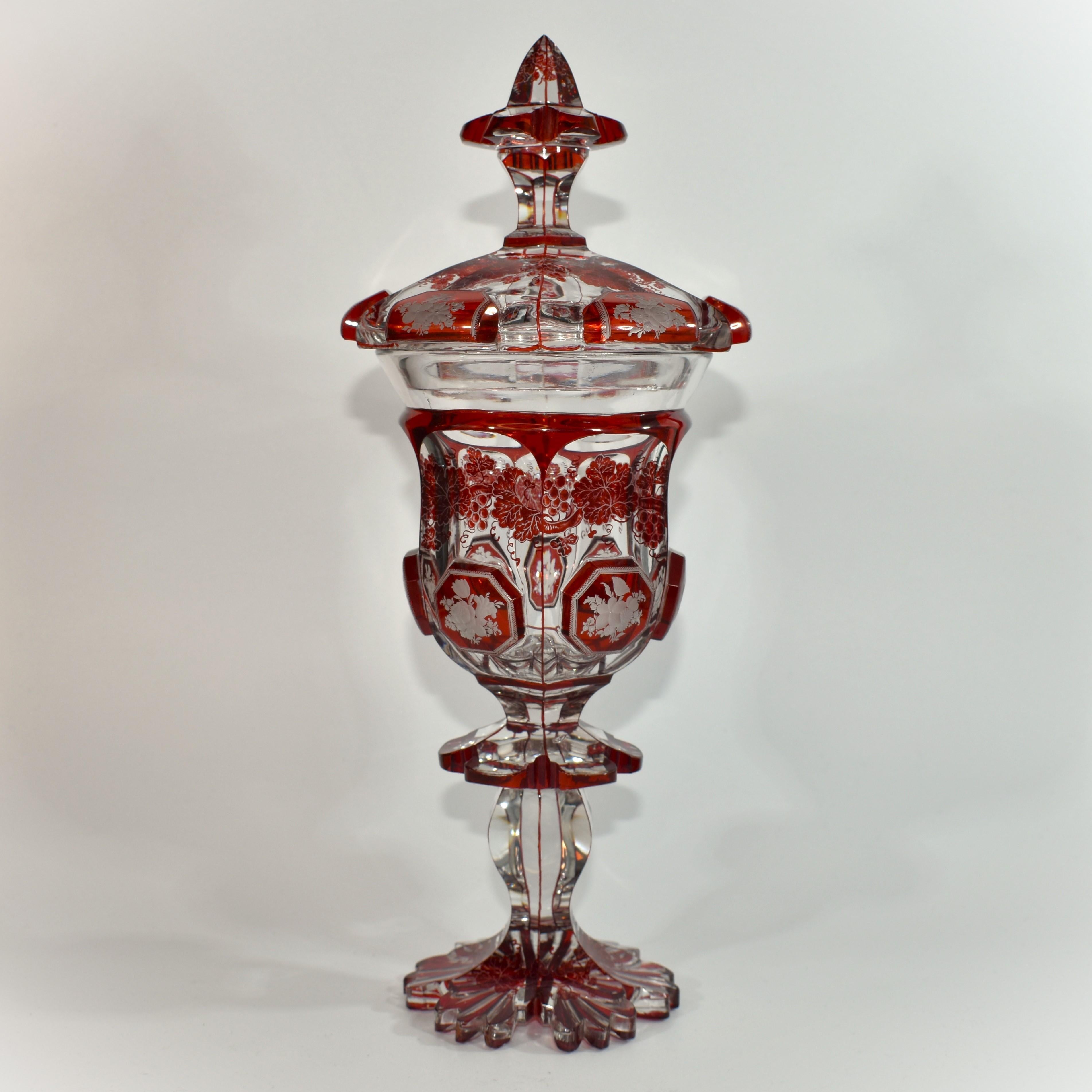 Fine Goblet and Cover of the Highest Quality Bohemian Glass of the 19th Century

Clear and Ruby-Red, with Ruby-Red Decoration and Engraving Hand-work

Decorated with Vines and Bouquets

Stands on a Scalloped Foot with Flared Base at the