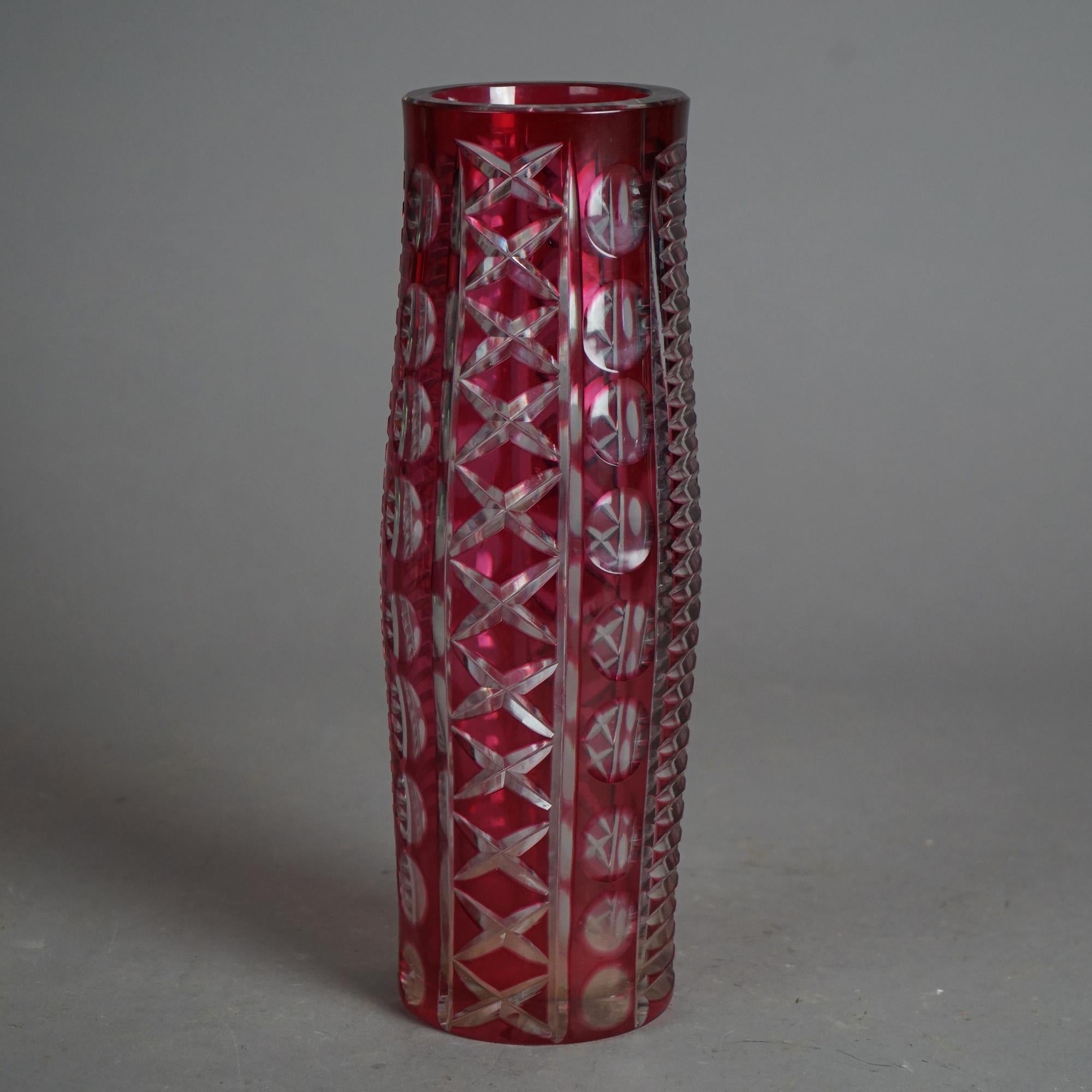 An antique Bohemian vase offers cut to clear ruby glass construction in stylized cylindrical form, c1920

Measures - 12