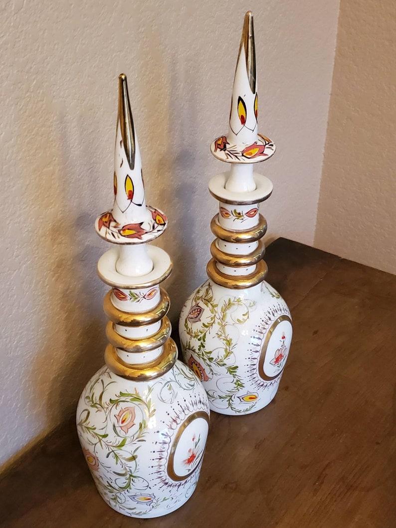 A rare, stunning pair of Bohemian partial gilt and enamel art glass decanters, handmade in Bohemia, destined for the Ottoman Market, between 1890 to 1905.

These beautiful, decorative antique decanters were hand crafted and painted with